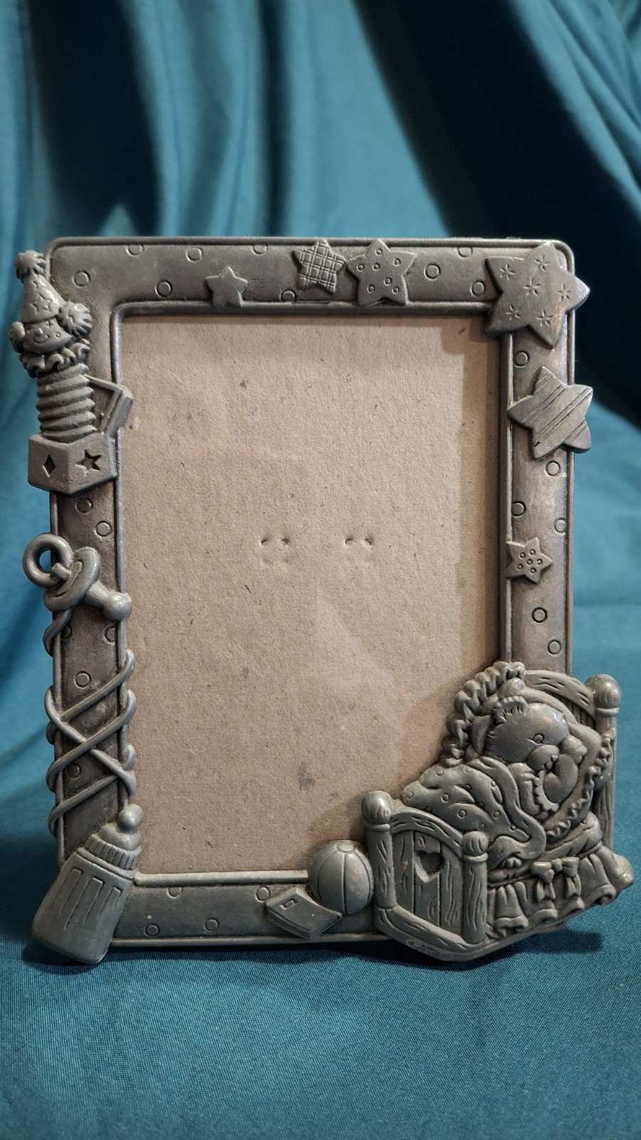 Pewter Baby Picture Frame sleeping teddy bear, a toy jack-in-the-box, and stars