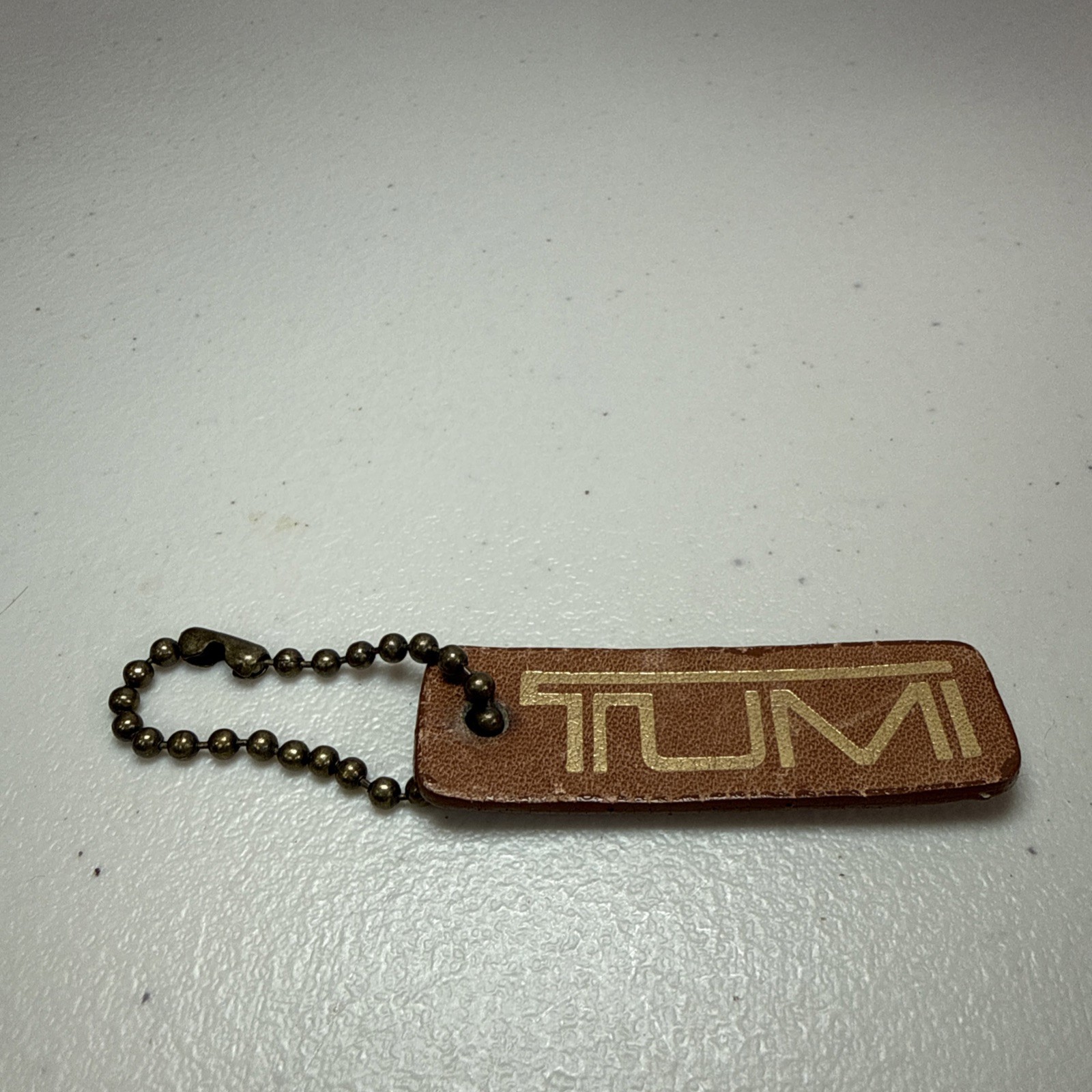 TUMI Brown Leather Gold Print Hang Tag Keychain  2 3/8” Used