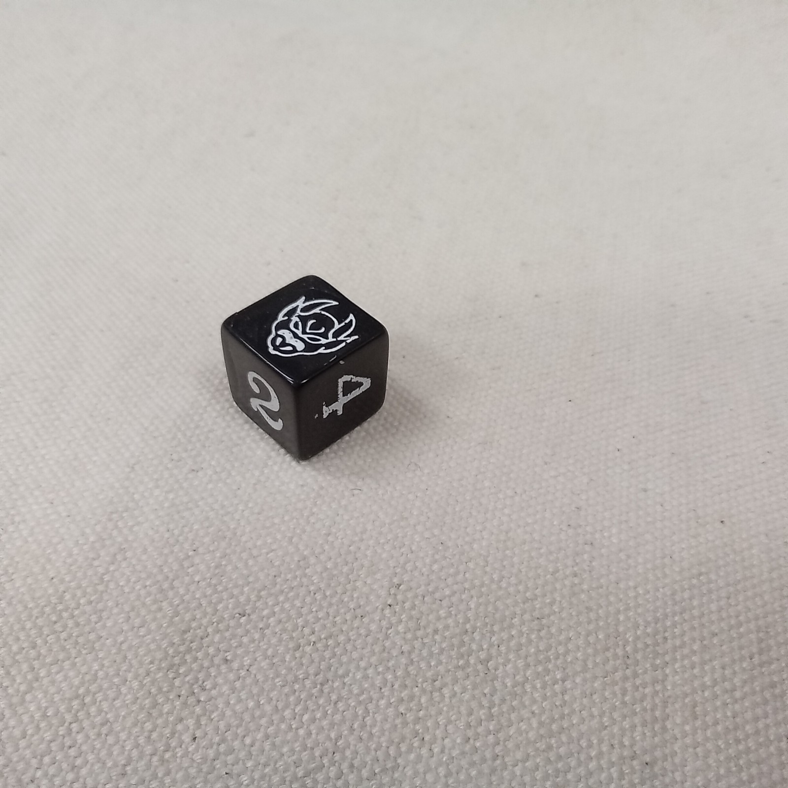 Gamescience orc demon dice for random encounters, white ink on black