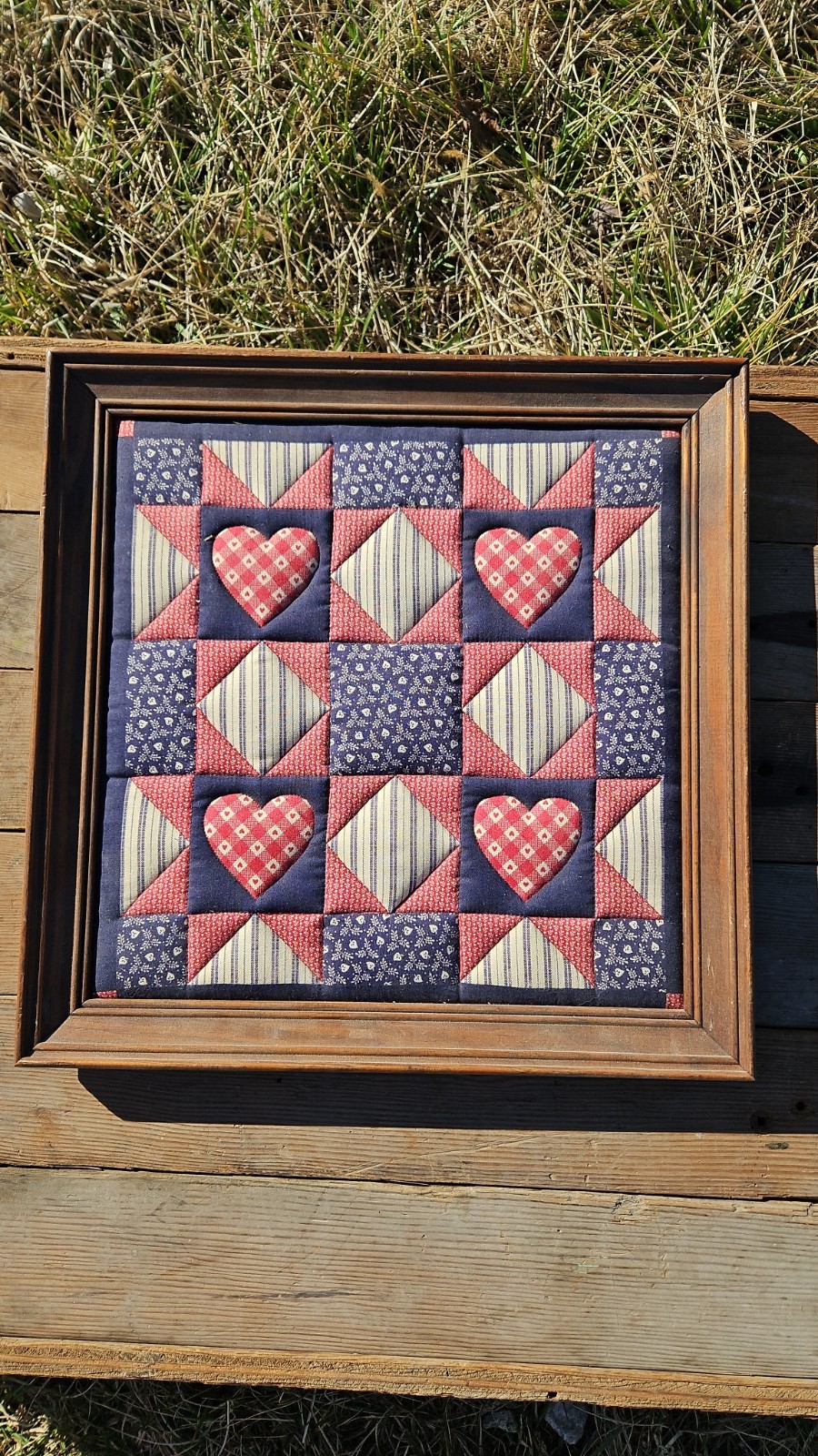 framed textile art piece featuring the  Hearts quilt pattern