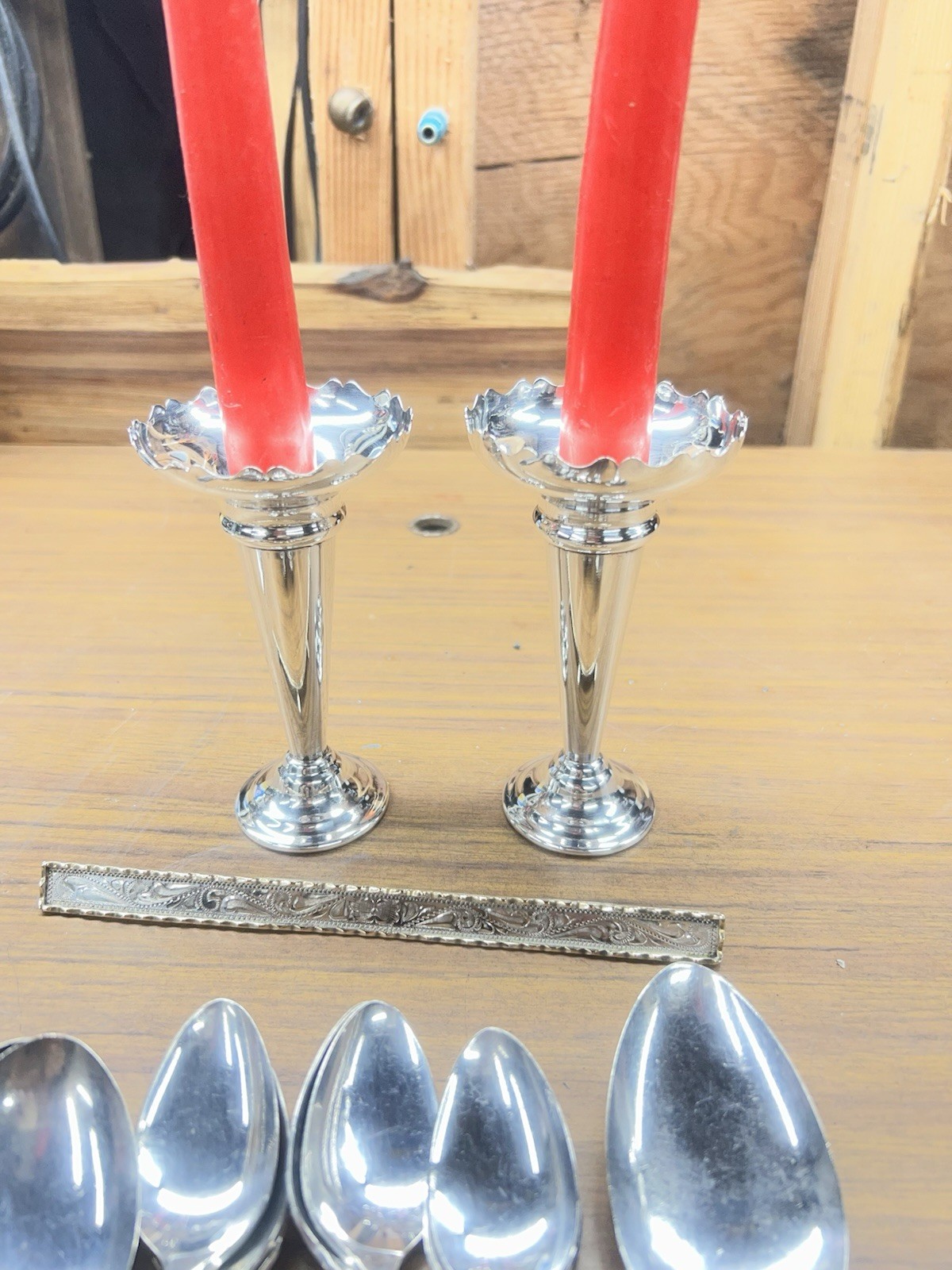 set of silver-plated taper candle holders with a scalloped edge design.