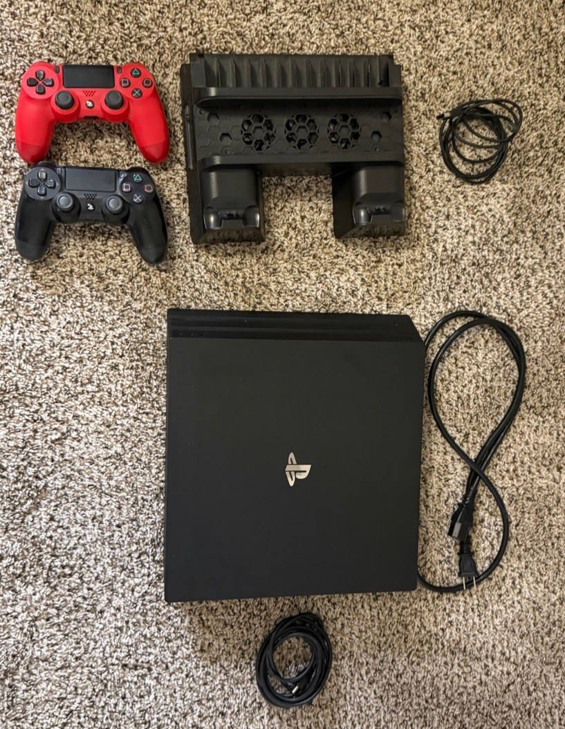 Sony PlayStation 4 Pro Console with Controllers, Charging Dock, and Power Cables