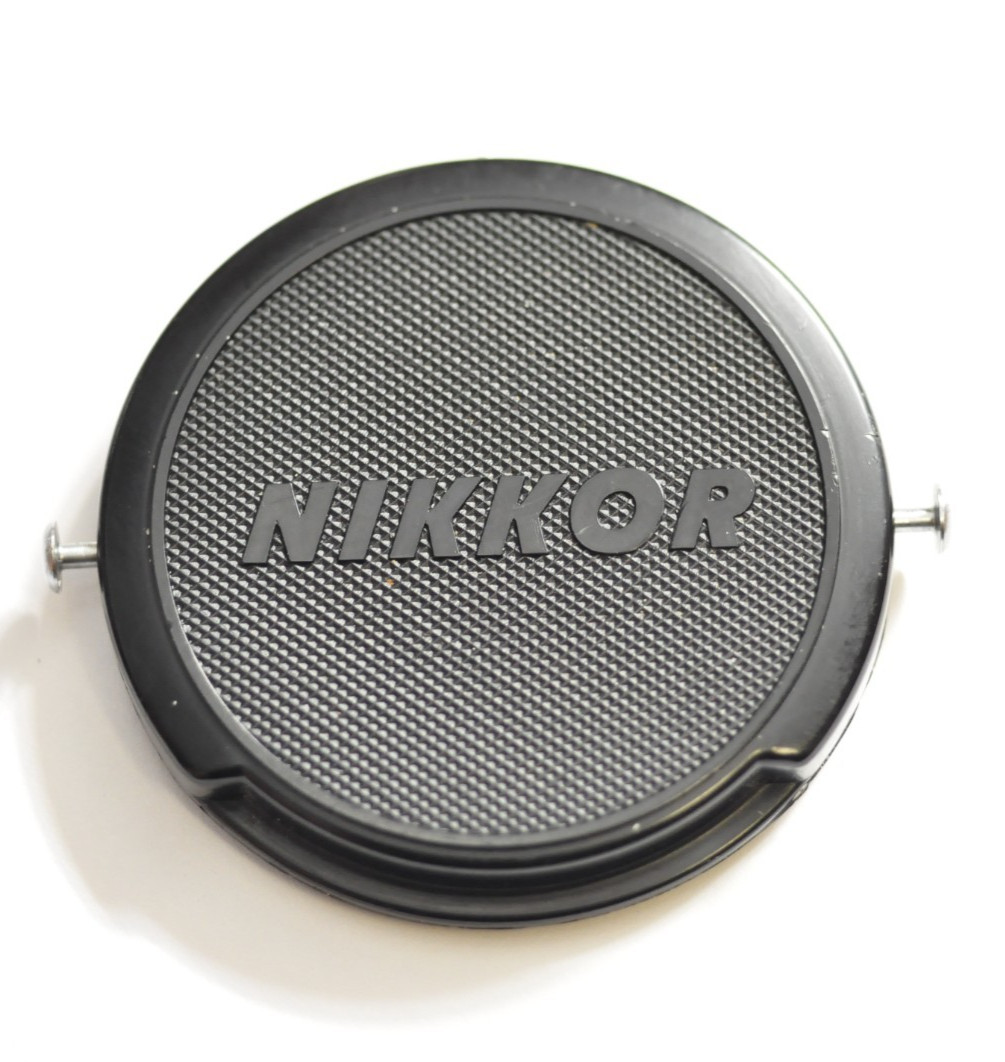 Early Nikon Nikkor style 52mm pinch on front lens cap as shown.