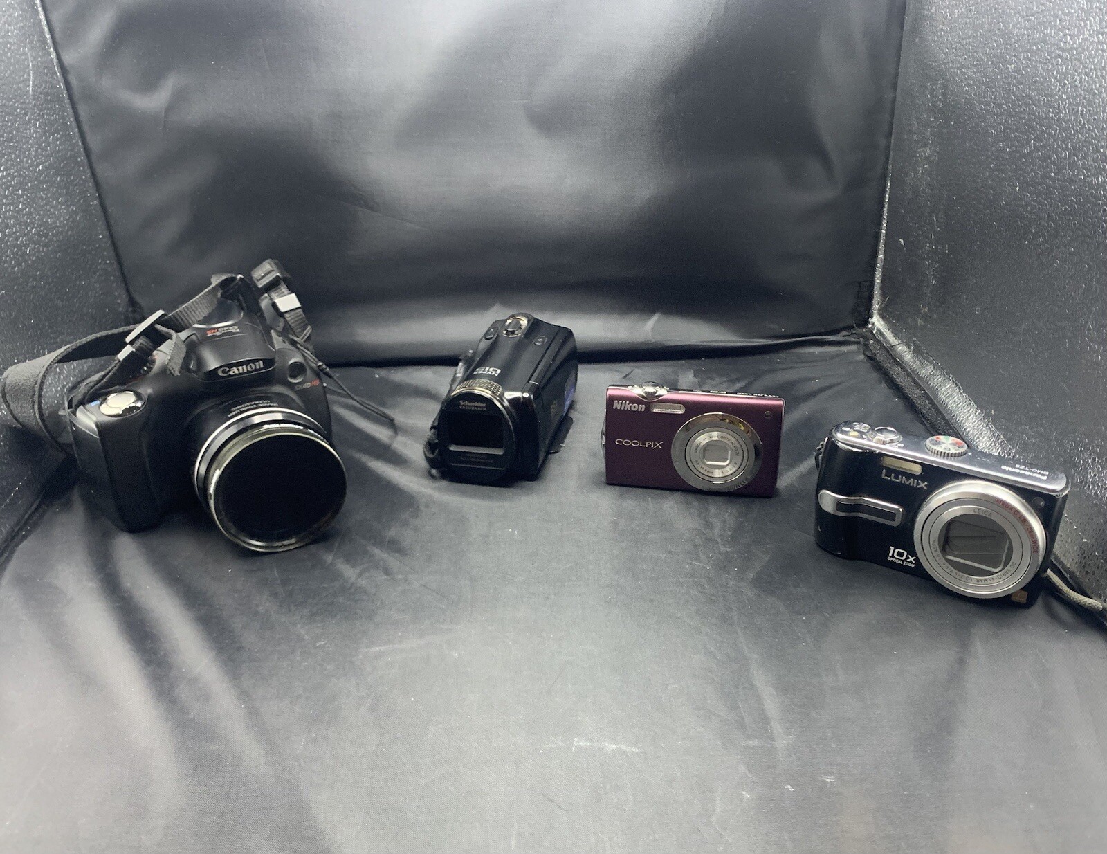 Lot of 4 Cameras  - Canon, Nikon, & LUMIX  ETC.- AS-IS-USED