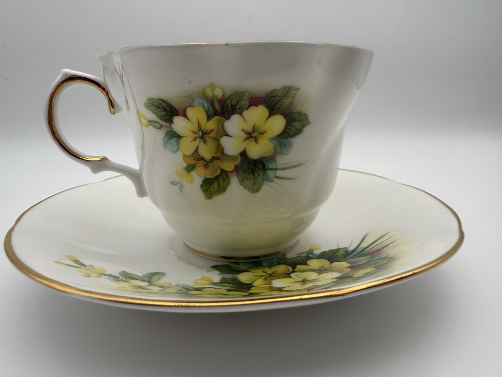 VINTAGE ROYAL MINSTER TEA CUP AND SAUCER YELLOW FLOWERS GREEN LEAVES