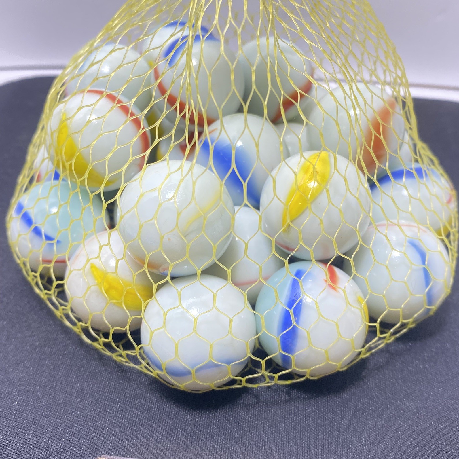 Vintage marbles lot of 25 Shooters white swirl with red, yellow and blue stripes