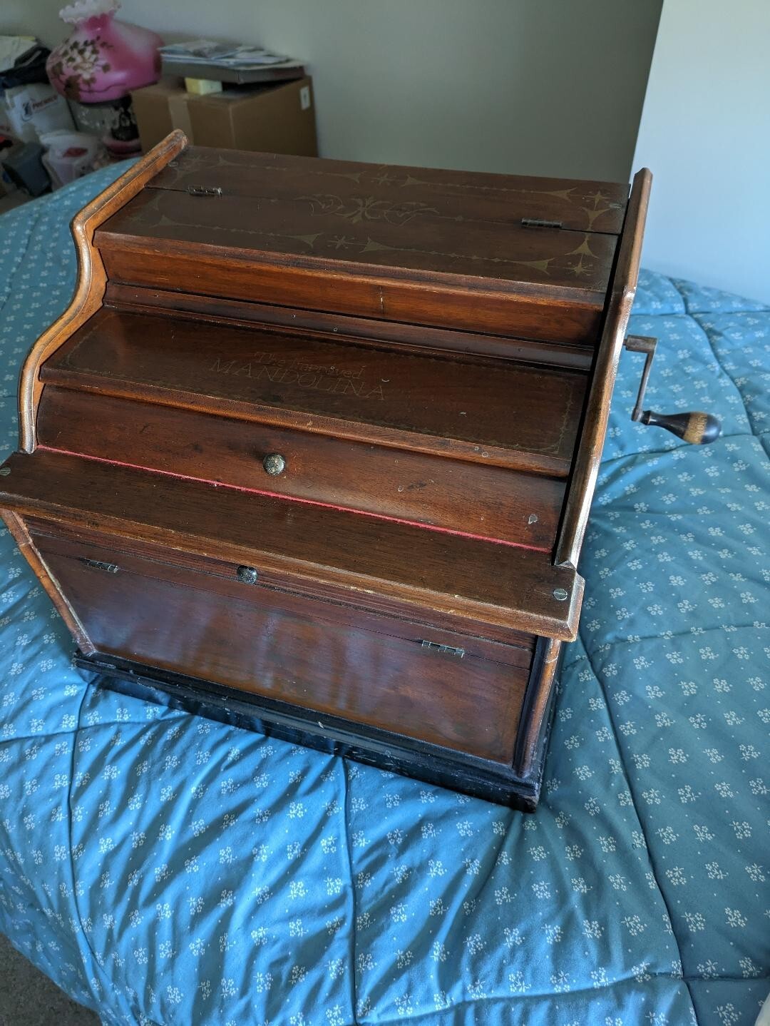 Vintage Mandolina paper roller organ; with four music rolls; needs new bellows