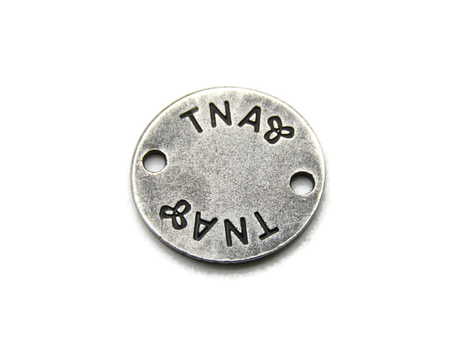 An Original TNA Product Charm Silver Tone