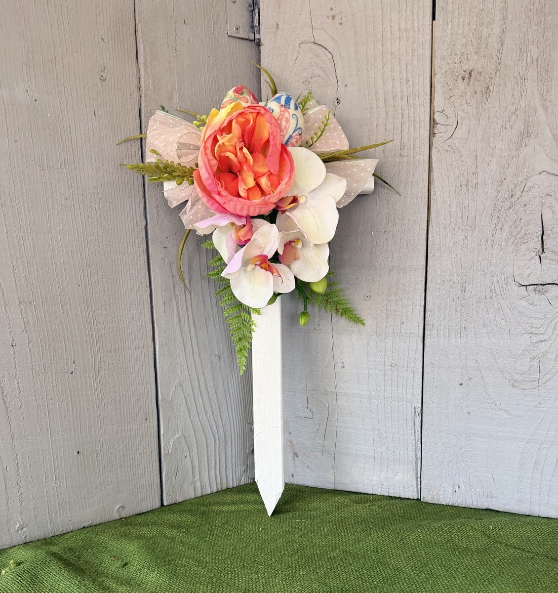 Cemetery cross , Easter grave decoration, pastel flowers for grave at cemetery