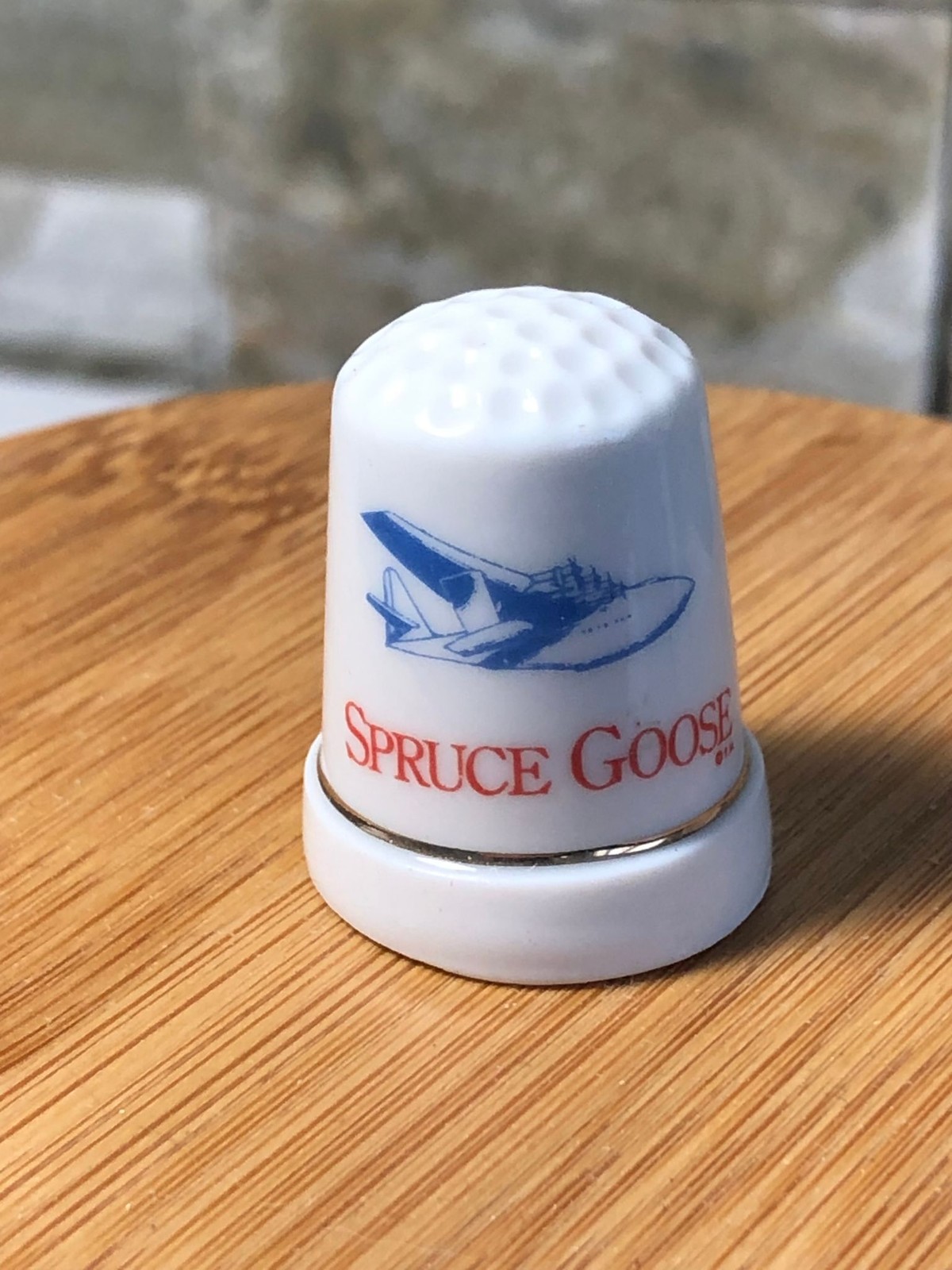 Spruce Goose Ceramic Thimble Souvenir Plane Blue Graphic Red Script Gold Rim