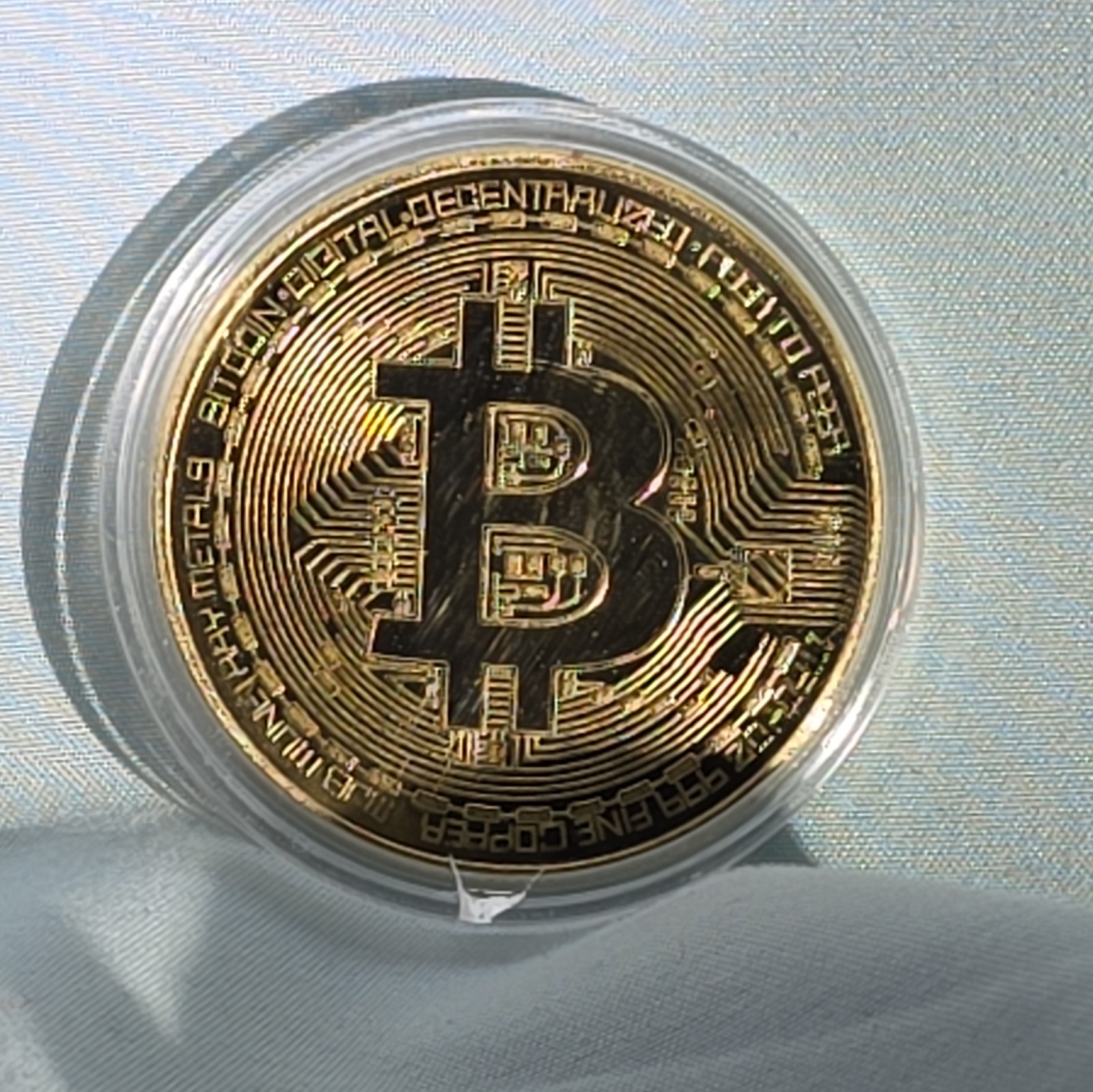 Bitcoin - gold colored Bitcoin in protective case.