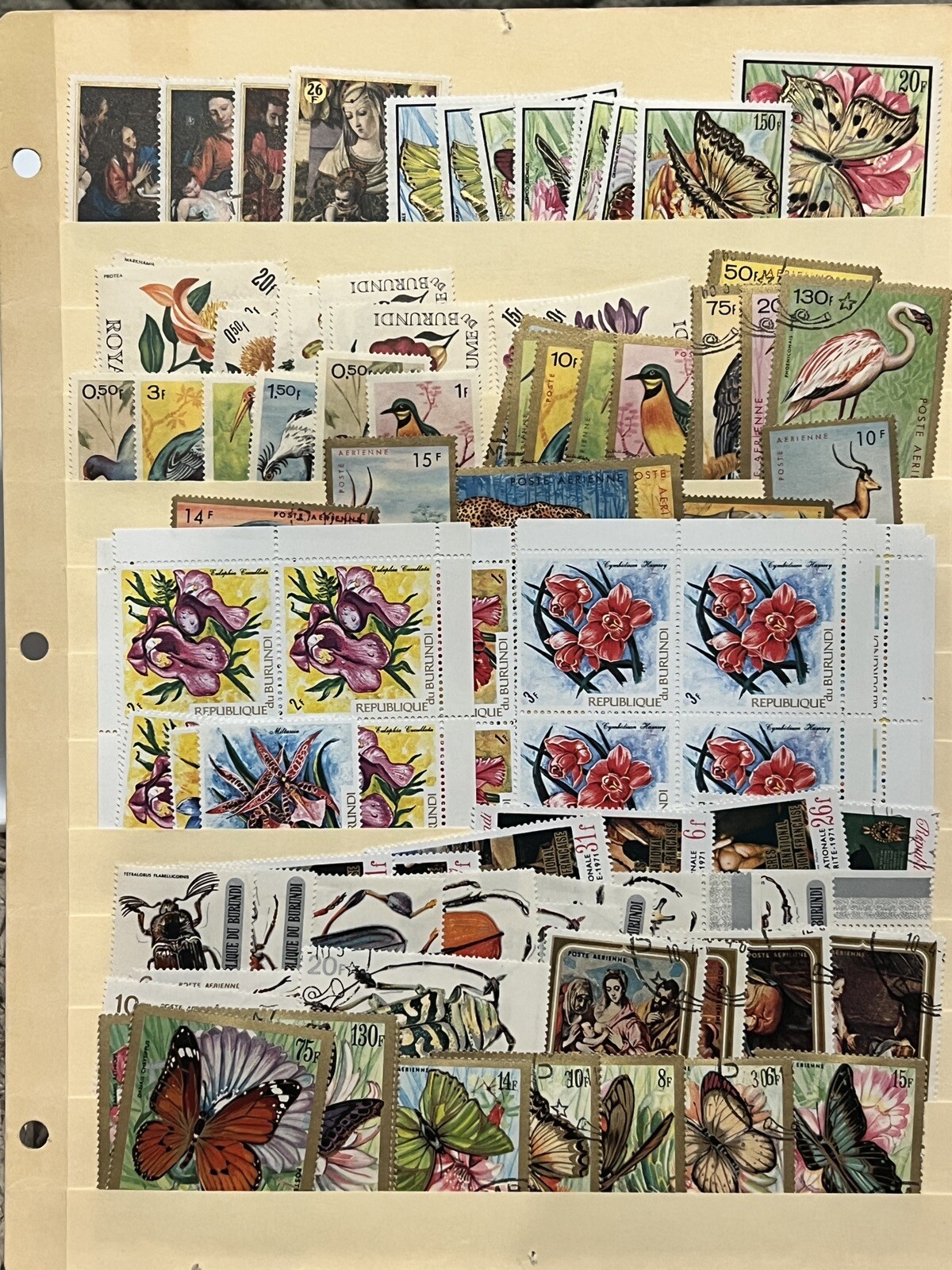 BURUNDI LOT OF STAMPS STUFFED IN A STOCK PAGE FLOWERS, BUTTERFLIES, BIRDS & MORE