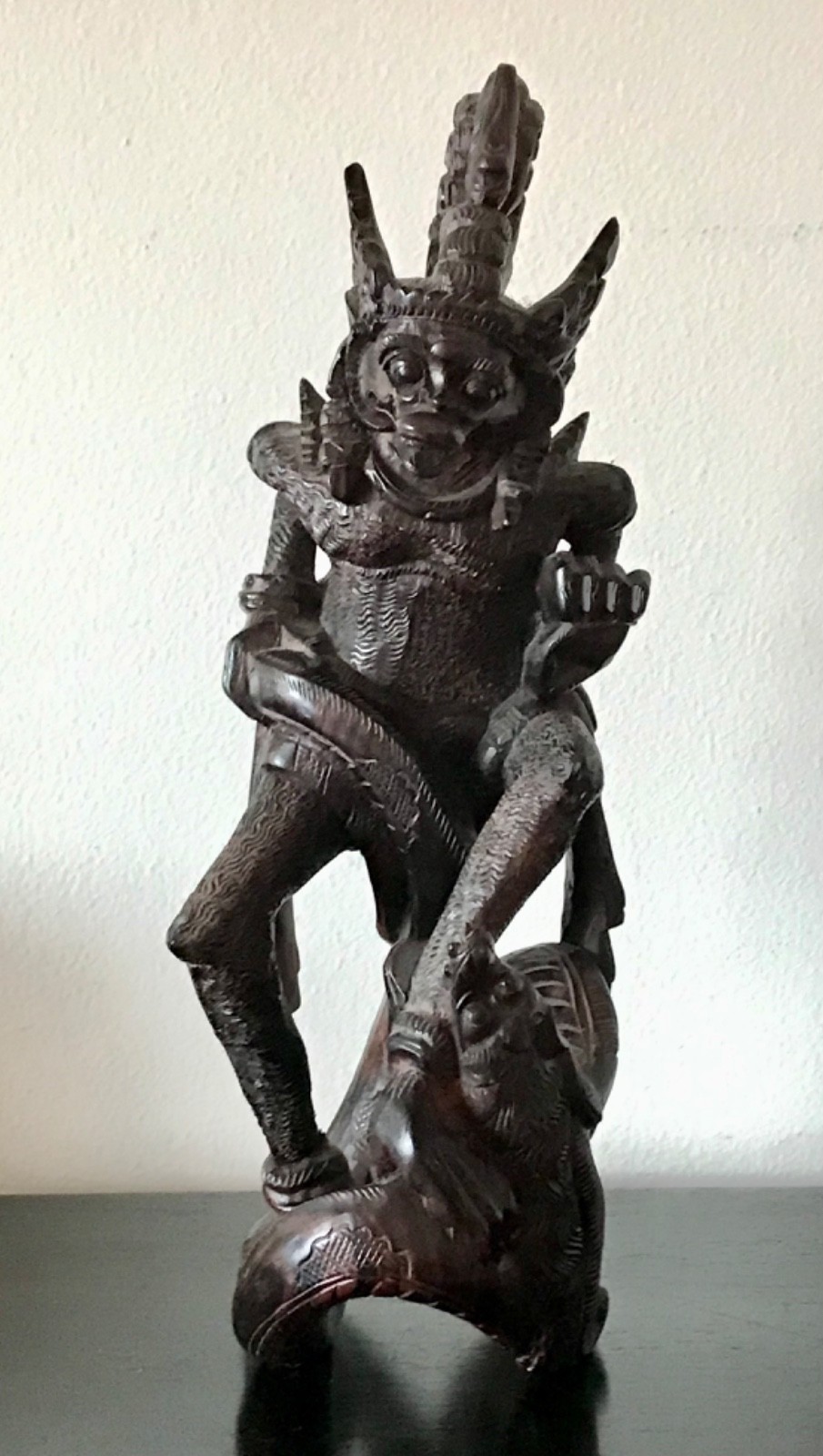 A Balinese Wood Carving, Carved as a Wing Deity Attacking a Dragon 13" Tall