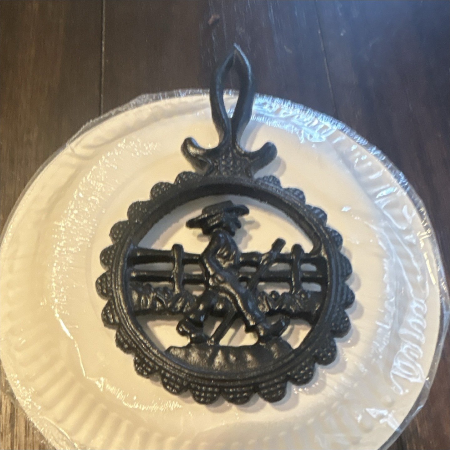Black Cast Iron Round Trivet with Cowboy and Fence Design