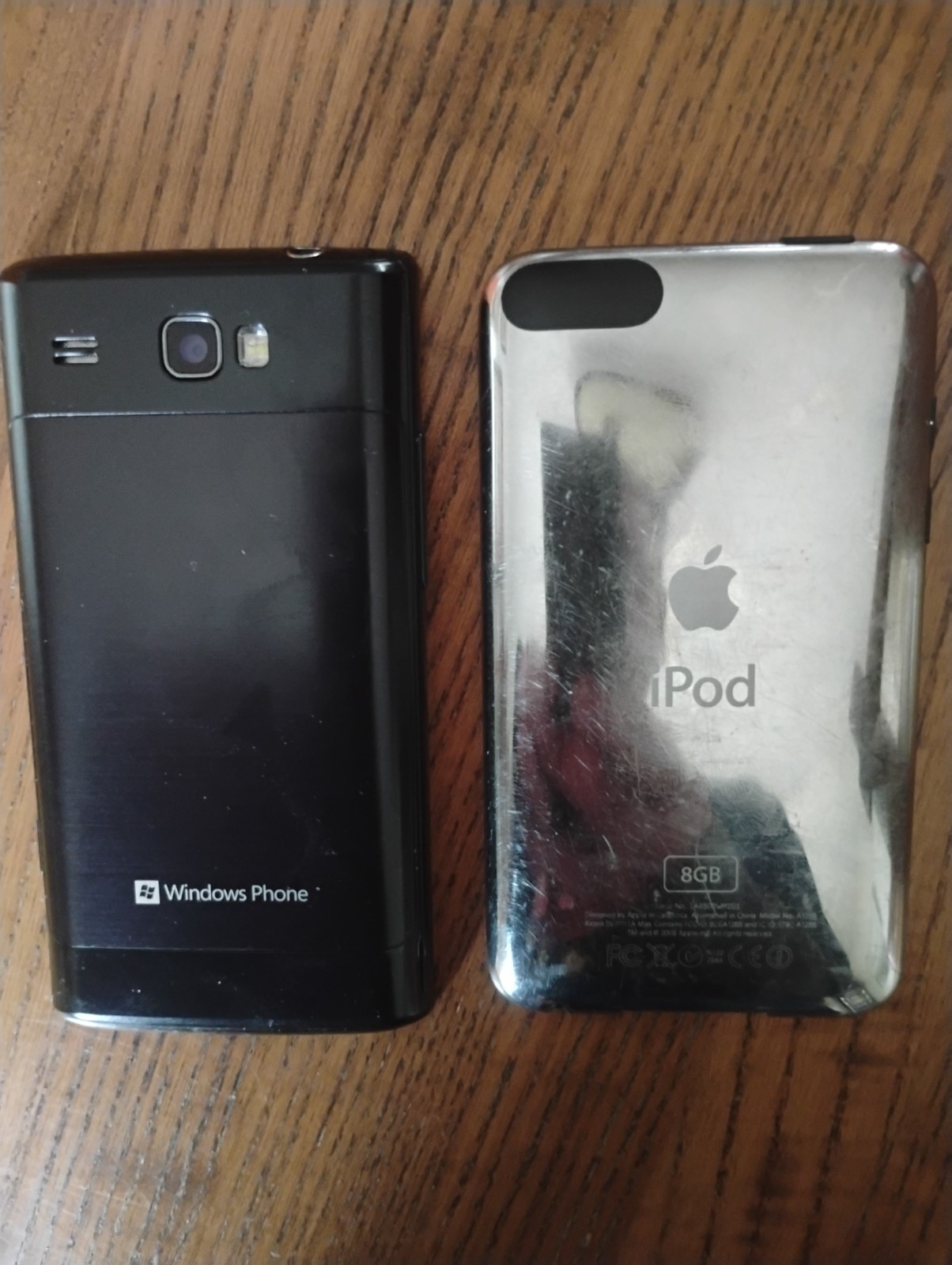 2 vintage cell phones apple iPod3 and Samsung windows phone