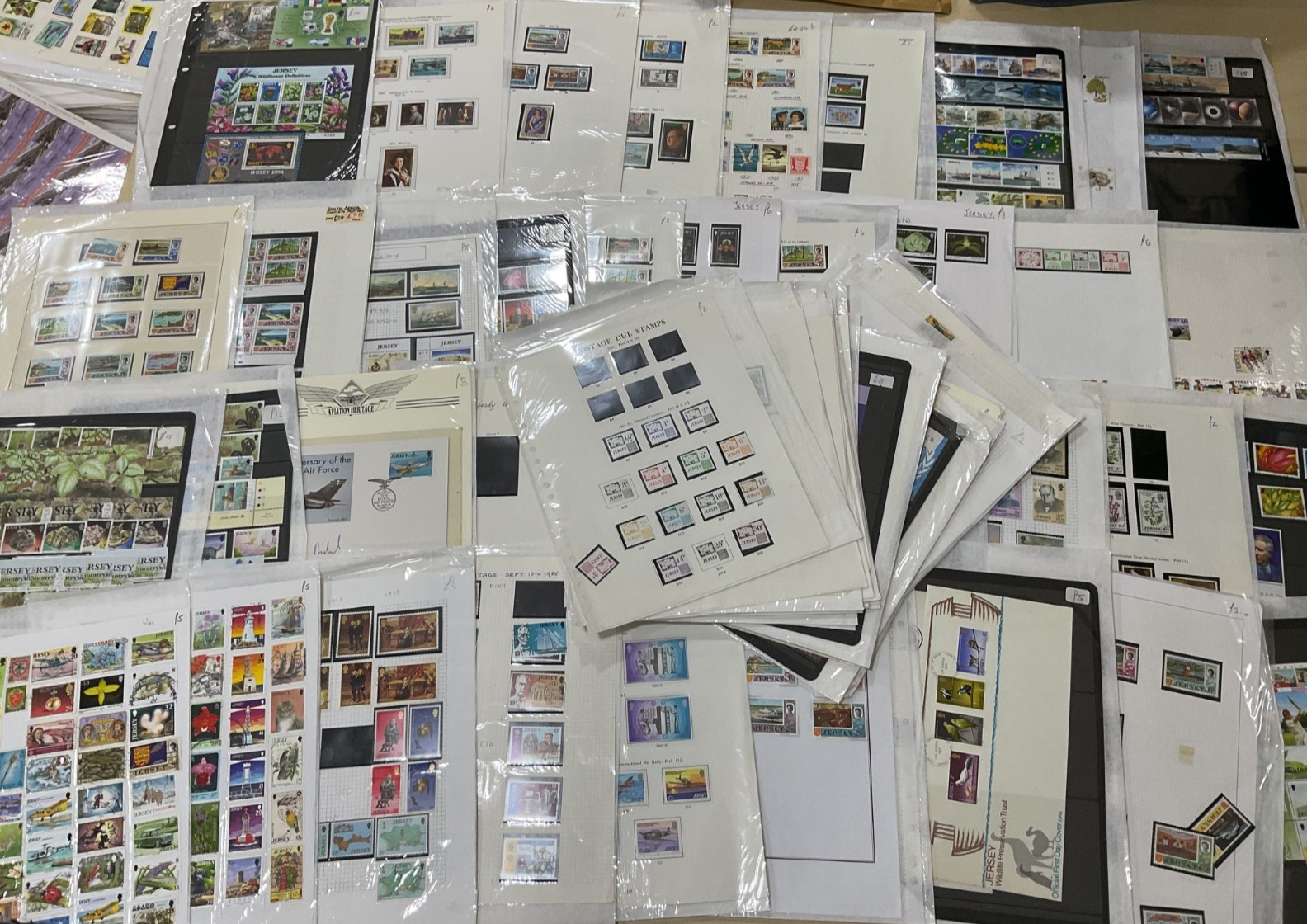 Jersey stamps. Ex dealer leaves/cards. Mint/used likely, as shown. 1.5kg. G36