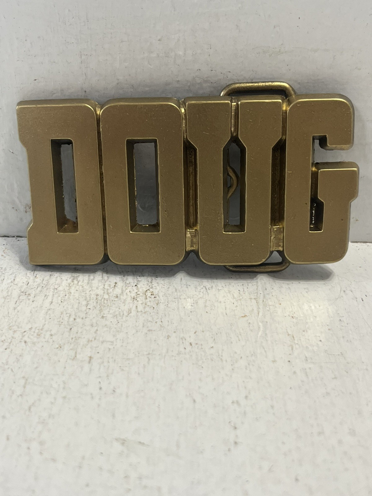 - Belt Buckle Vintage 1980’s Brass Colored Doug Name