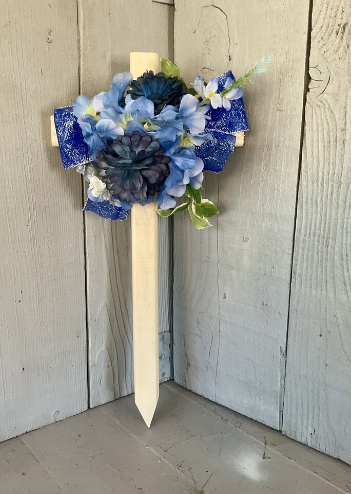 Cemetery cross , grave decoration, blue flowers for grave at cemetery
