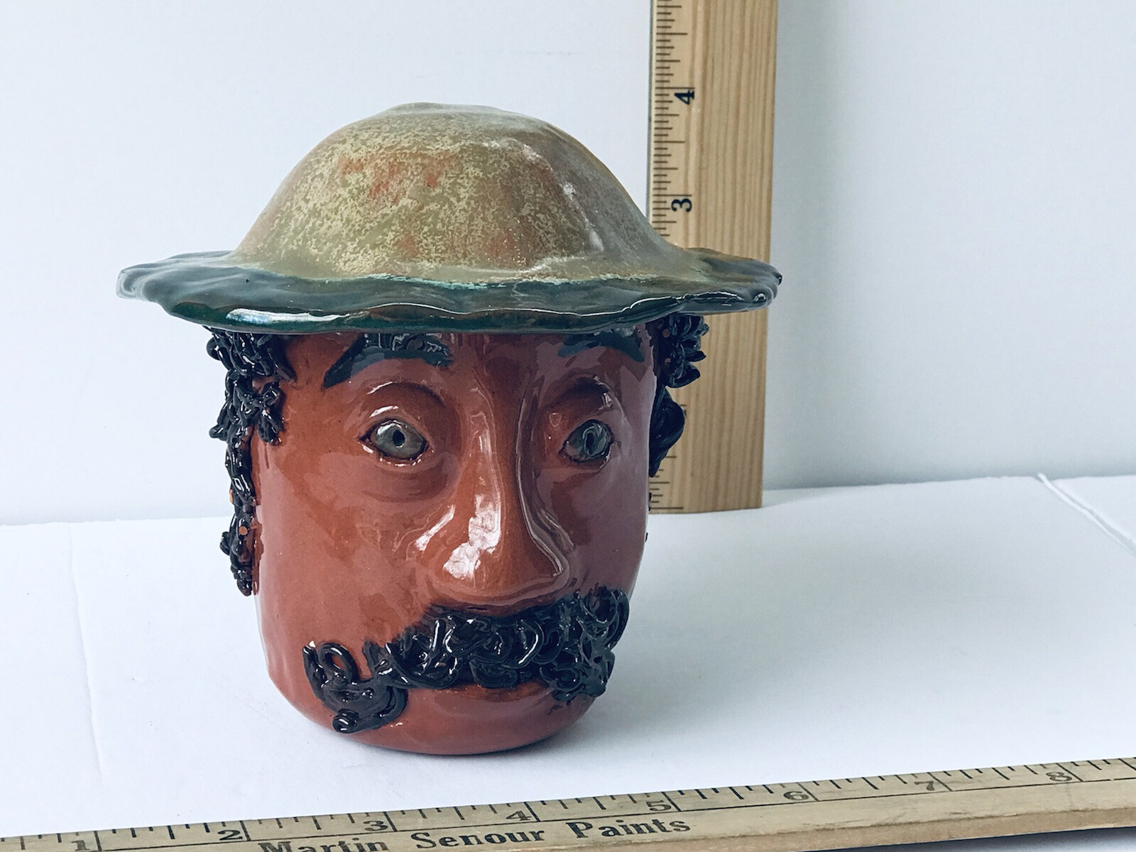 Glazed Pottery Bust man with hat, mustache and spaghetti curly hair. signed