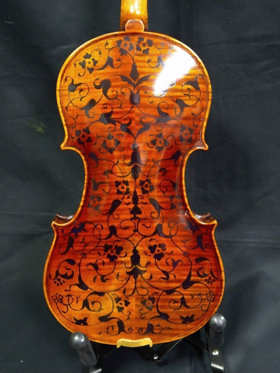 A handmade violin with a rare and beautiful design. Top quality maple back,