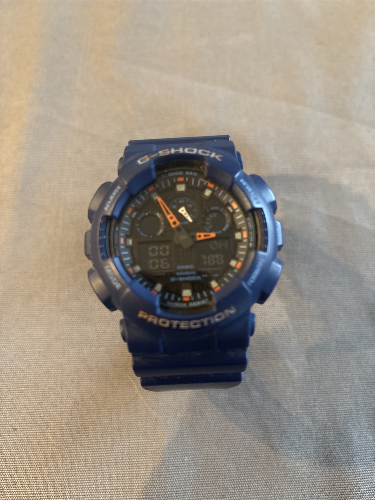 G-SHOCK- Casio G-Shock GA100L-2A Digital-Analog Men's Wristwatch Blue And Orange