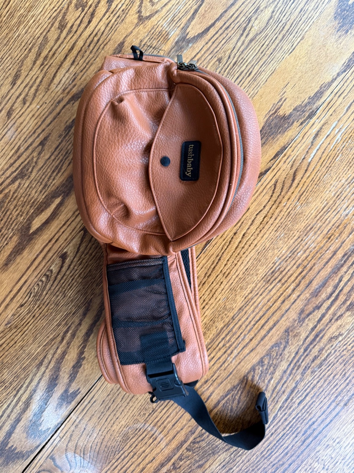 TushBaby Hip Carrier With Hands Free Attachment Vegan Leather Cognac and Black