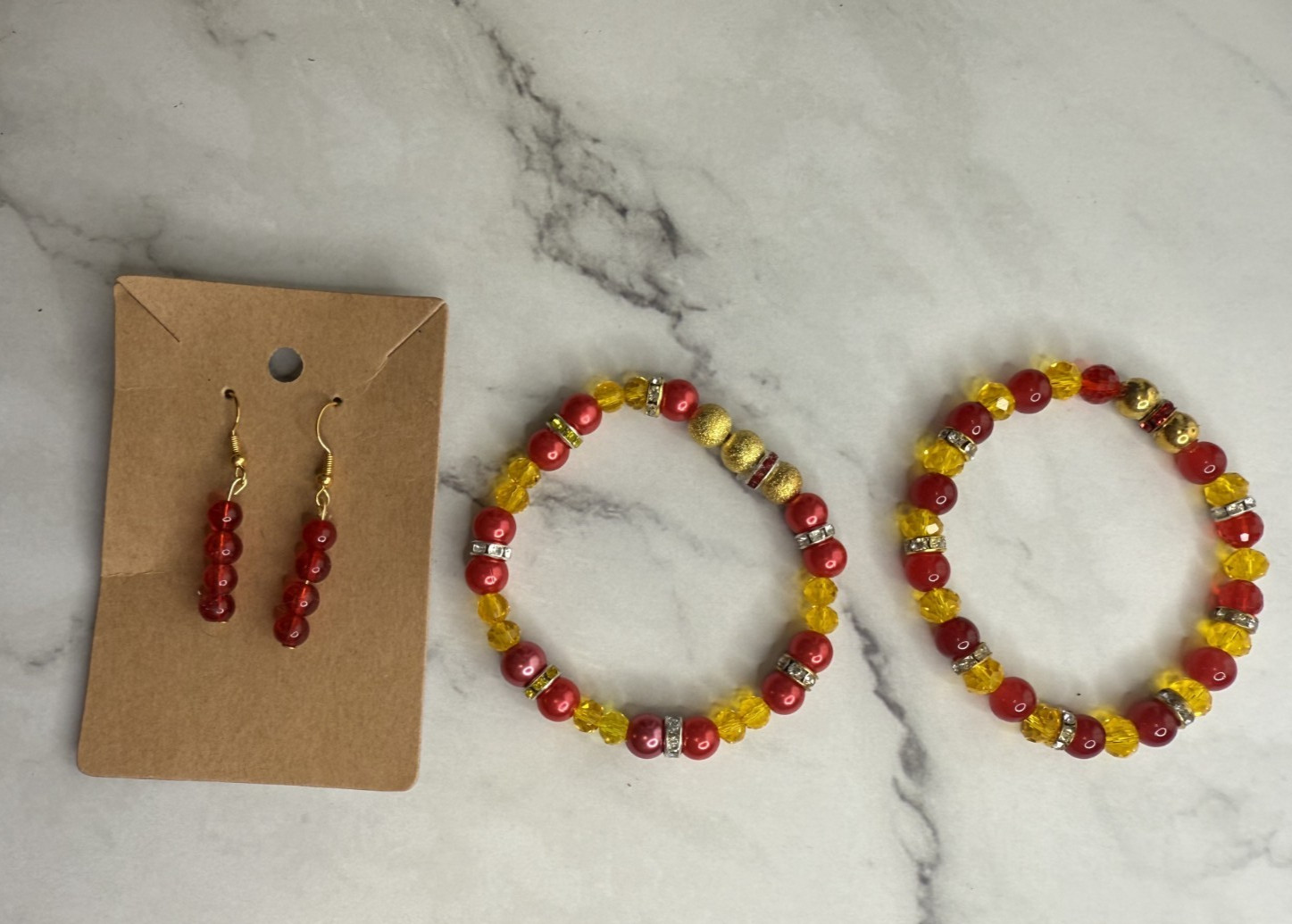 handmade beaded dangle earrings and bracelets yellow and red tones