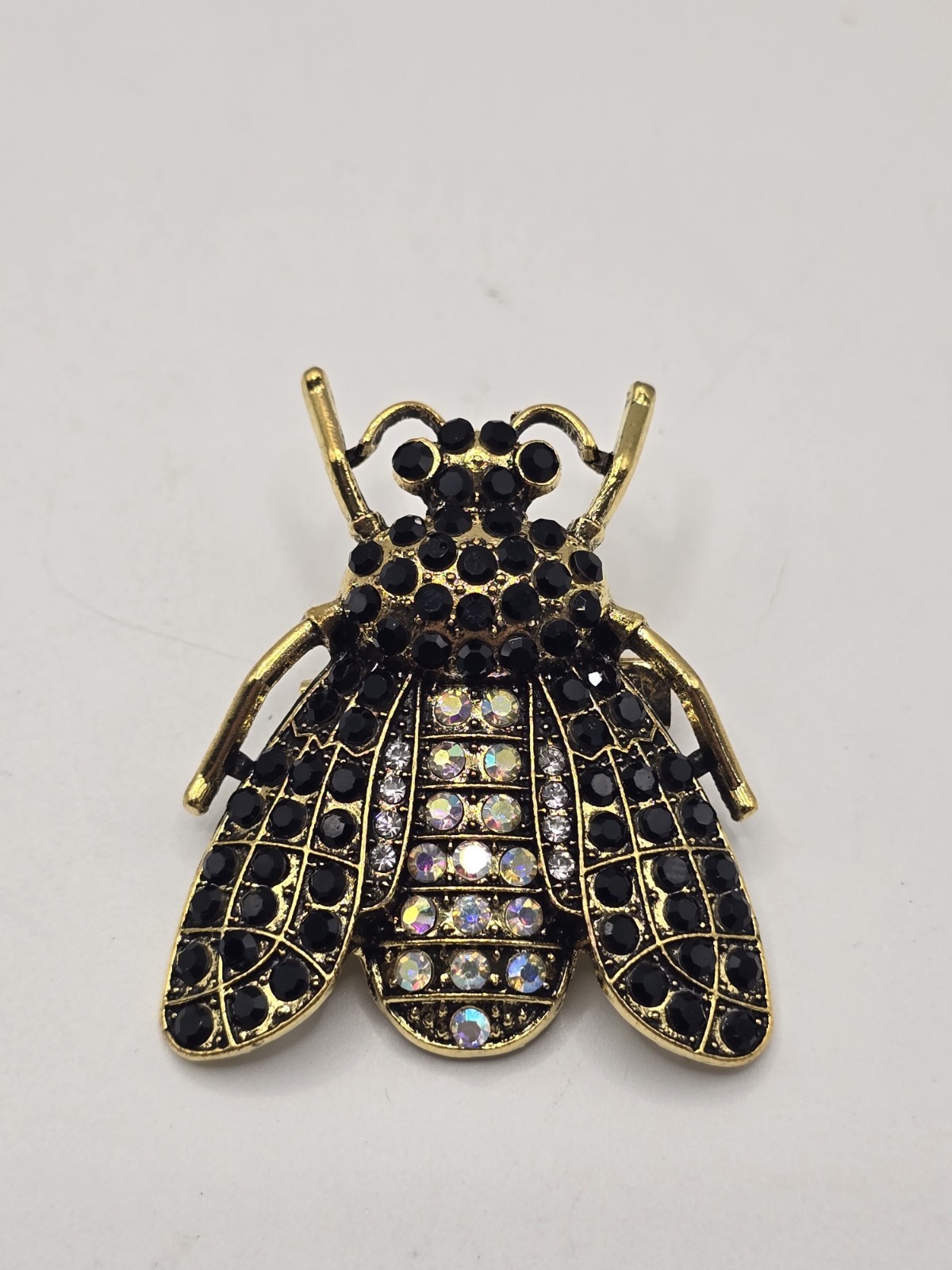 Vintage gold tone bee brooch with black and iridescent rhinestones insect pin