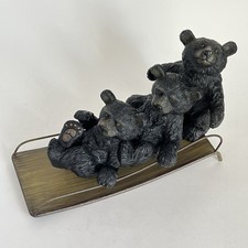 3 Playful Black Bears Riding A Metal Sled Anthropomorphic Whimsical Cabin