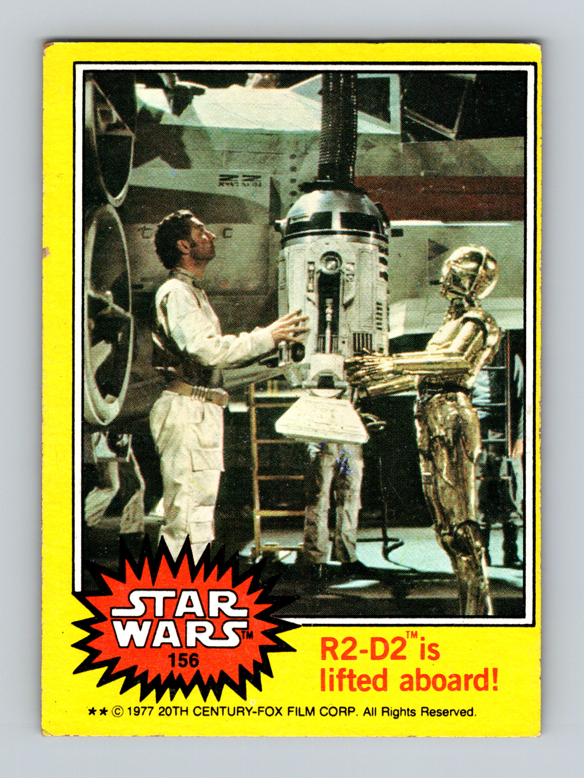 1977 Topps Star Wars Series 3 Yellow Card #156 R2-D2 is lifted aboard