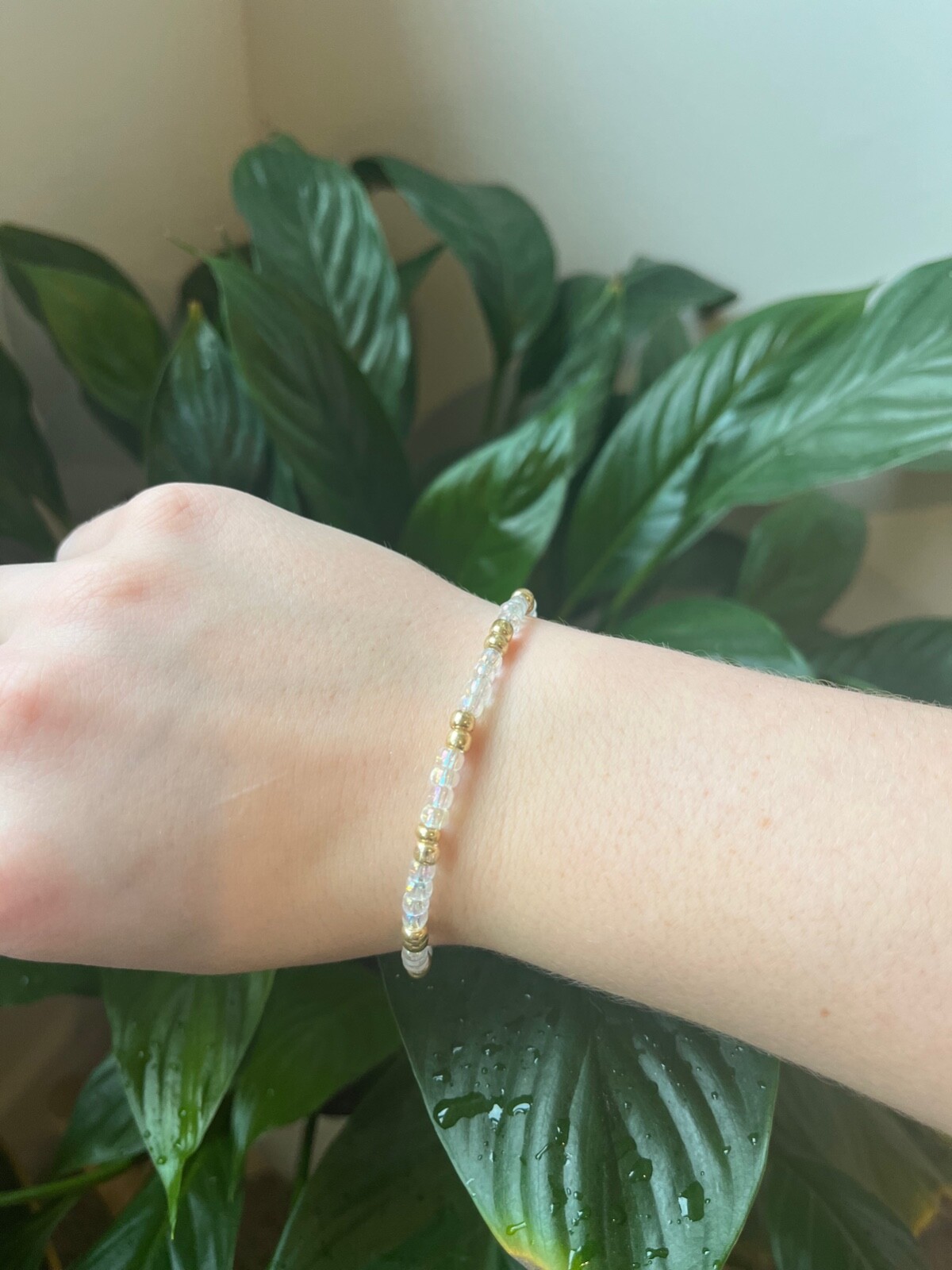 Beaded Bracelet with gold and clear beads on elastic.