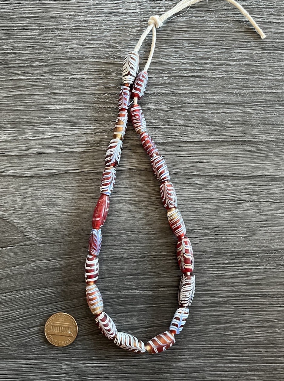 Short Strand of 21 Antique Venetian Glass “Feather” African Trade Beads