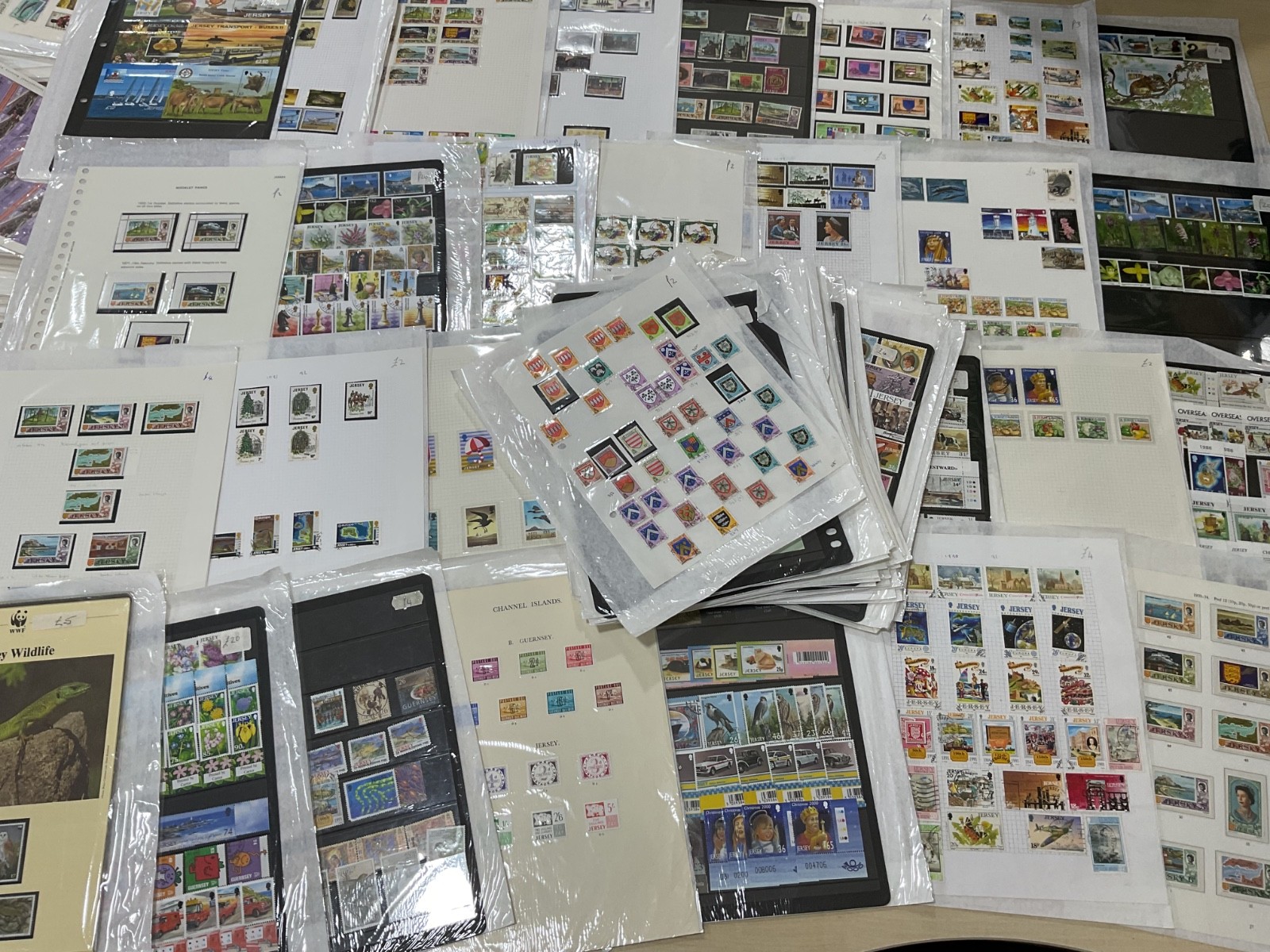 Jersey stamps. Ex dealer leaves/cards. Mint/used likely, as shown. 1.5kg. G35