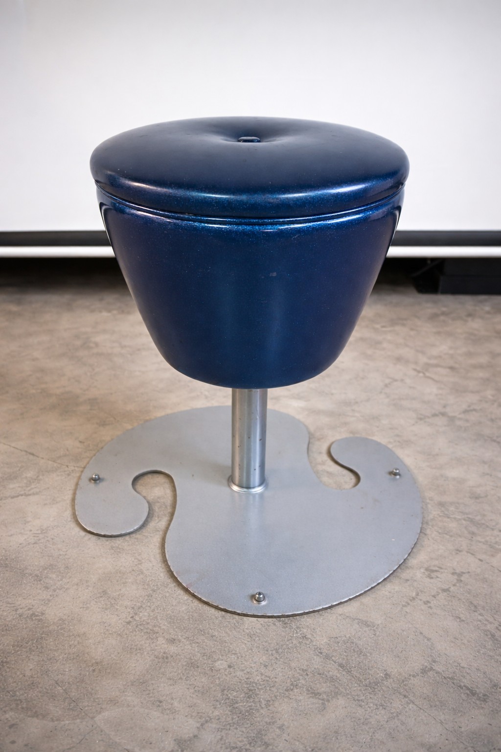 Vintage industrial pedestal stool with classic machine-age design. These stools