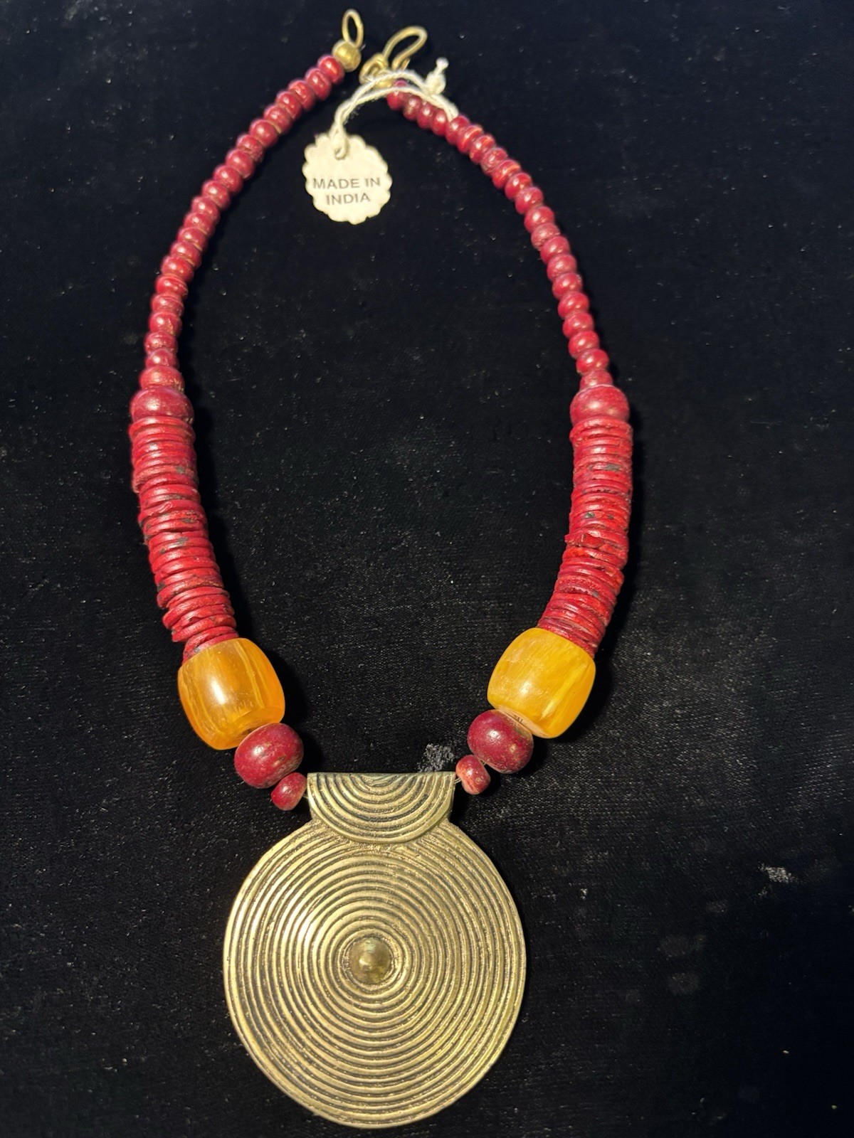 Tibetan dark red bead necklace with brass disc pendant