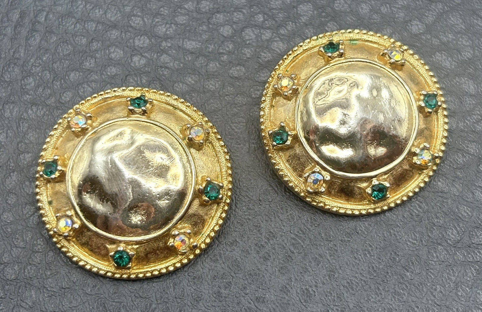 Vintage 80s Mogul AB Green Rhinestone Hammered Medallion Gold Tone Clip Earrings