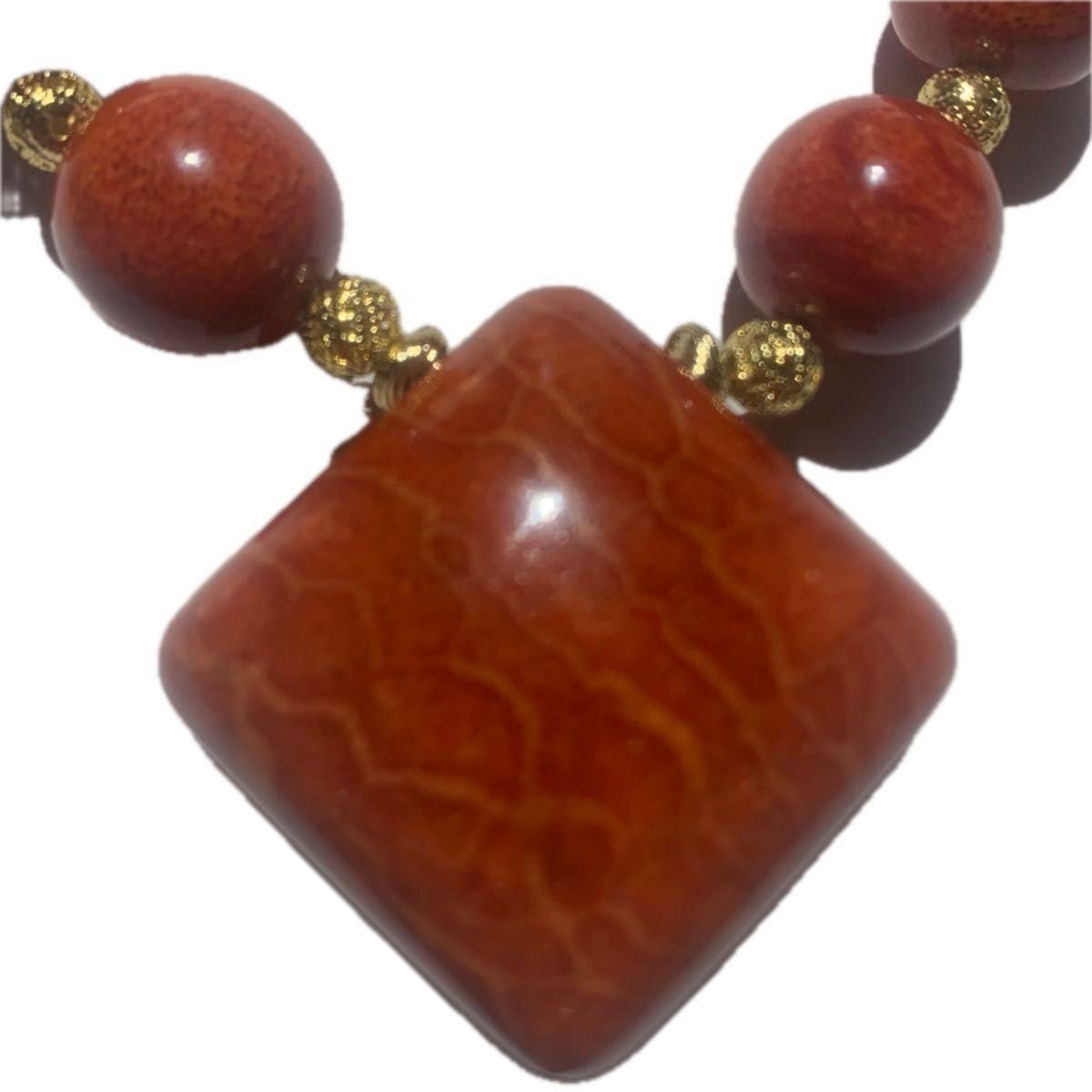 African coral necklace with large beads, square top, and gold hardware