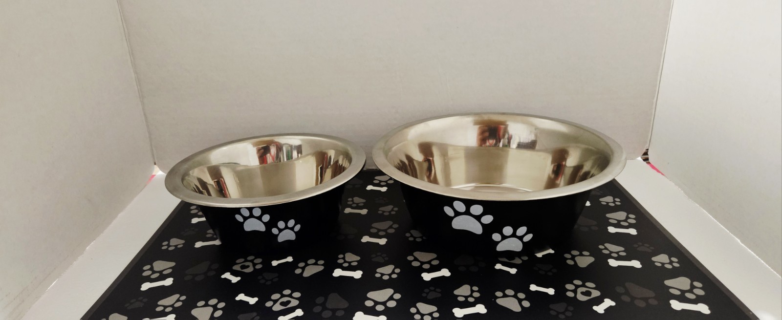Set Of Stainless Steel Pet Bowls & Waterproof Feeding Mat. Black W/ Paw Prints 