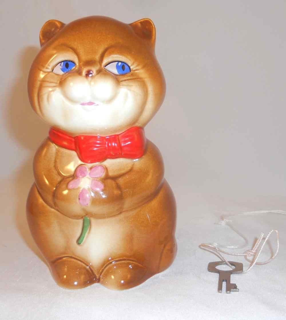 Cute Glazed Goebel Germany Porcelain Still Penny Bank w/ Key Cat Holding Flower