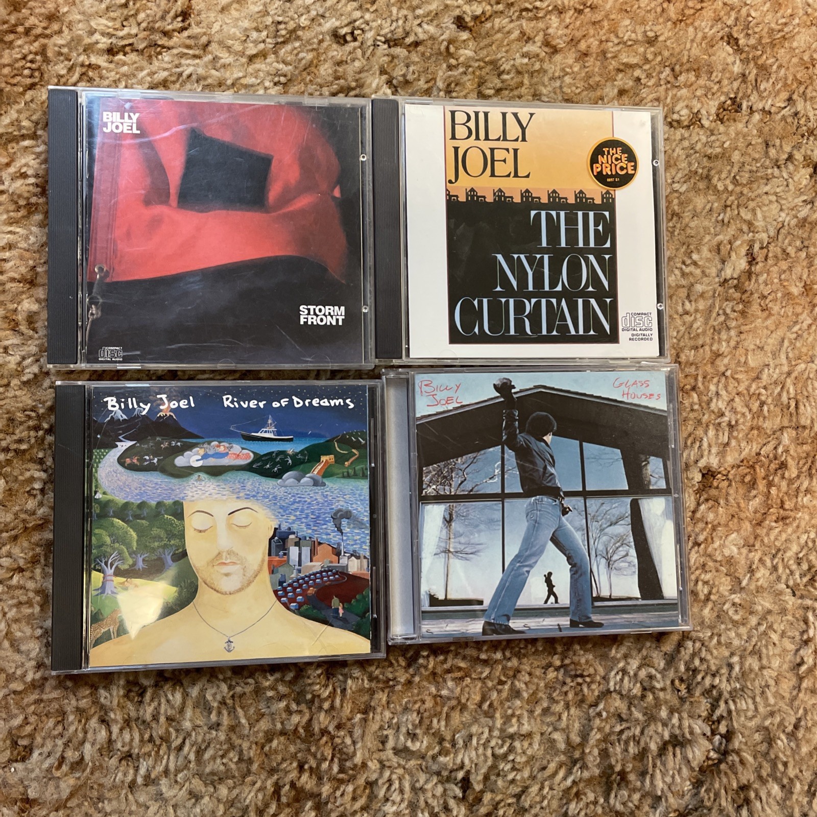4 Billy Joel CDs: Glass Houses; The Nylon Curtain; River of...; and Storm Front