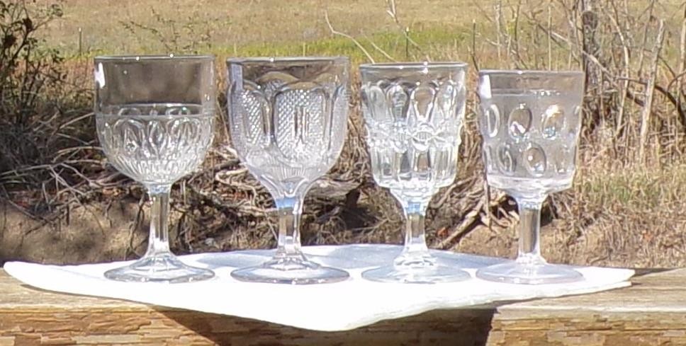 EAPG CLEAR set of (4) GOBLETS, LOOPED OVALS, EARLY BUCKLE, BOWTIE, EGG in SAND