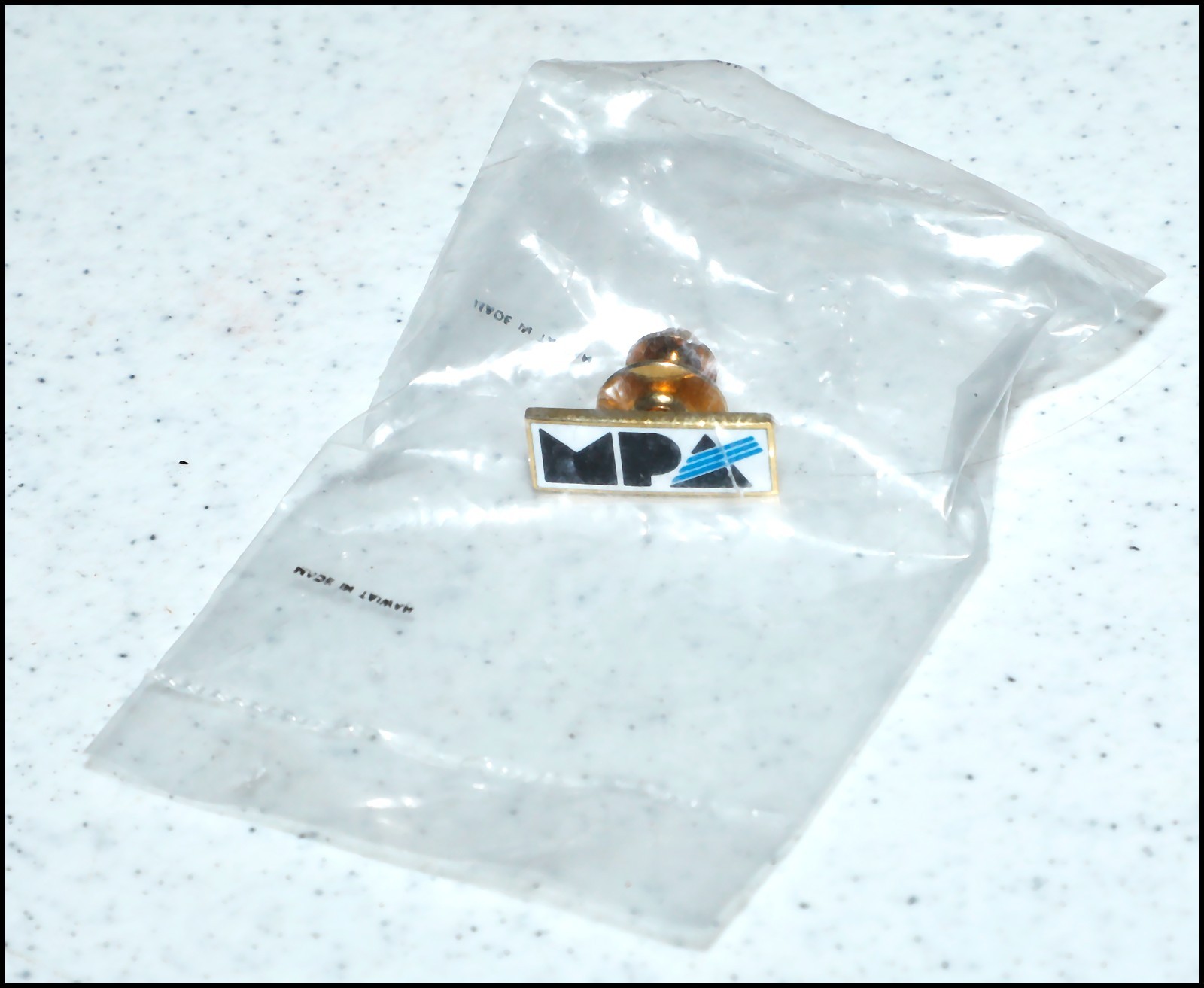 Metal Minolta MPA lapel pin with clasp. NEW