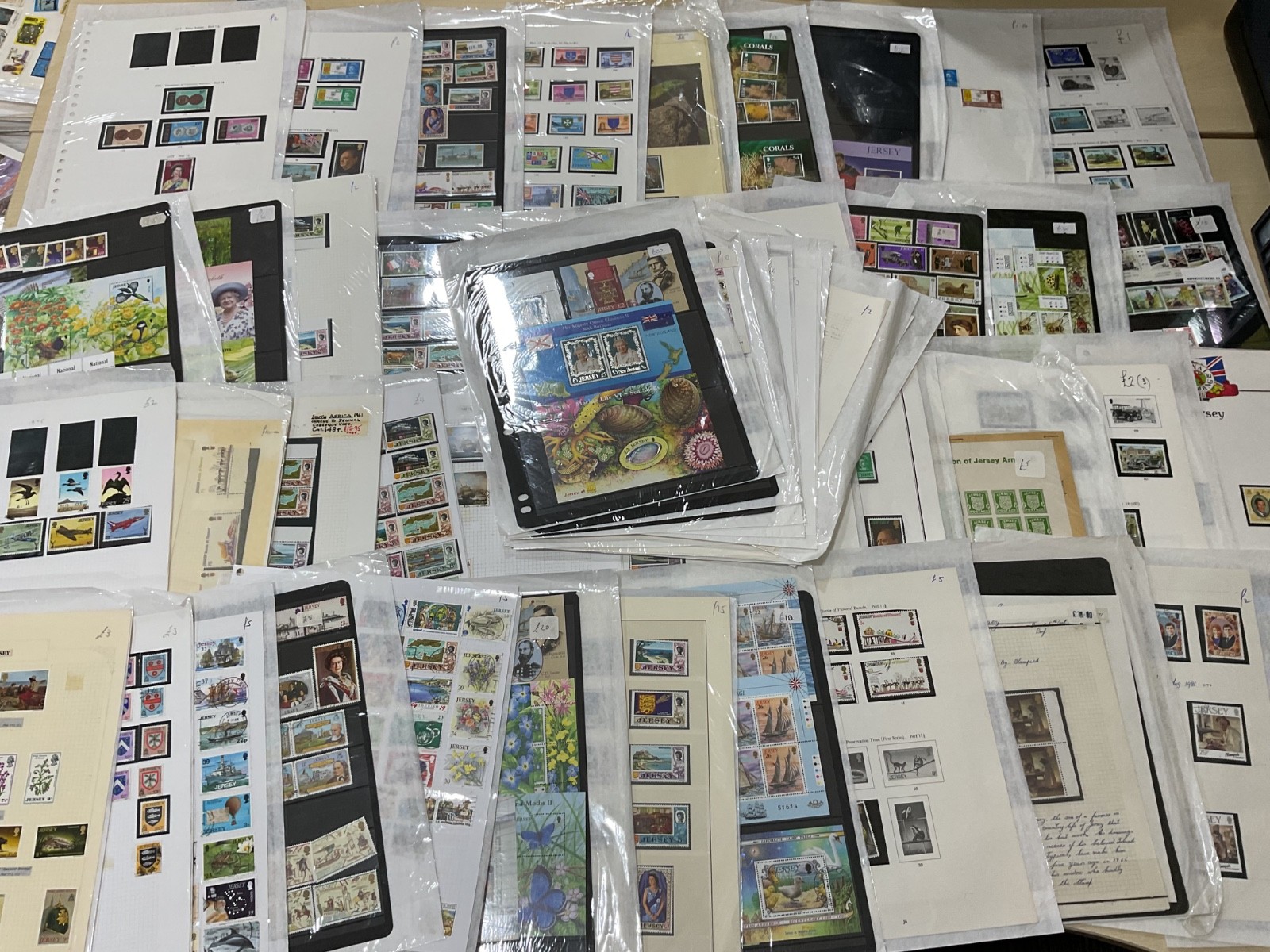 Jersey stamps. Ex dealer leaves/cards. Mint/used likely, as shown. 1.5kg. G39