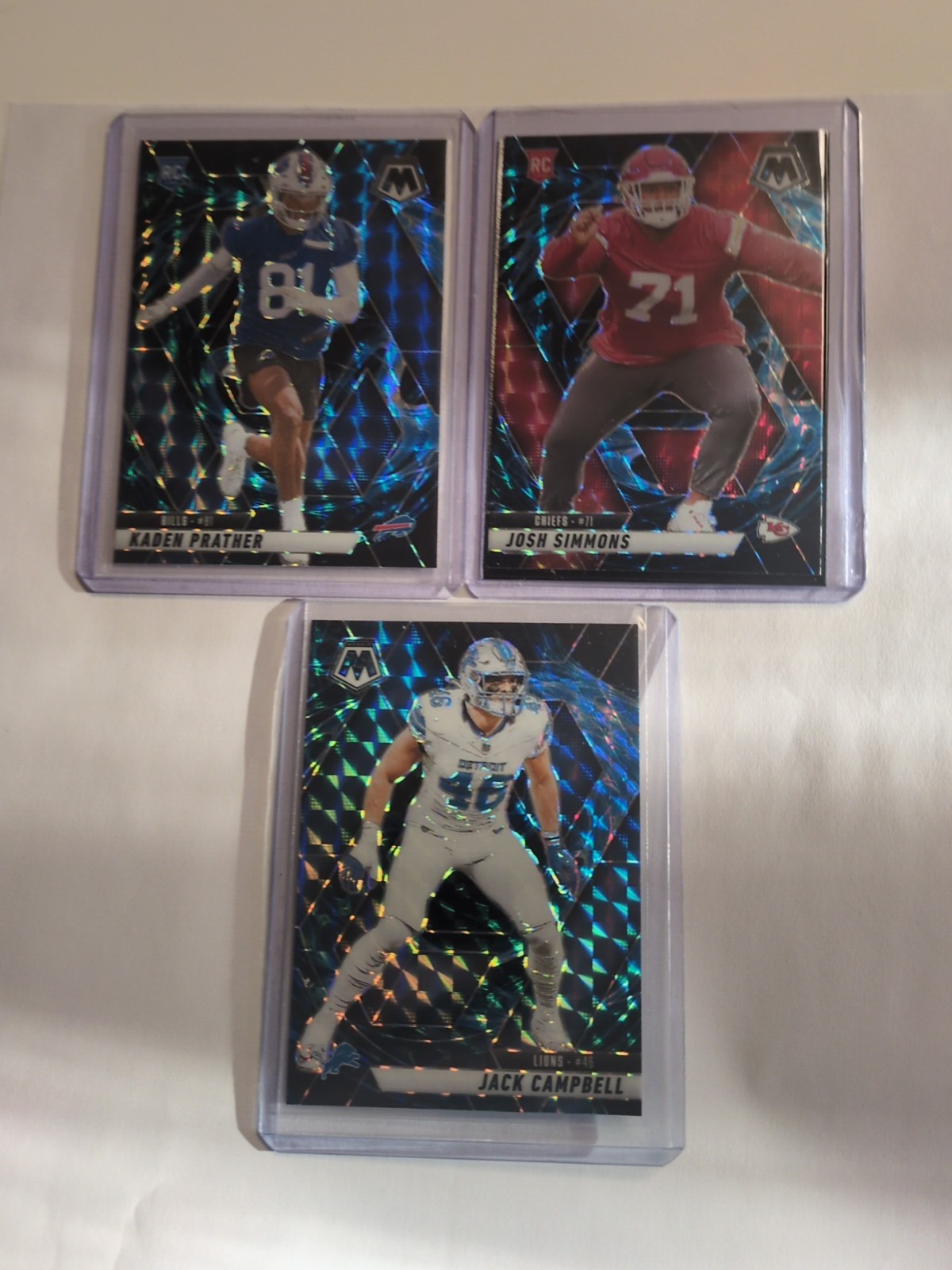 NFL Genesis Case Hits - 2025 Mosiac Jack Campbell/Kaden Prather/Josh Simmons