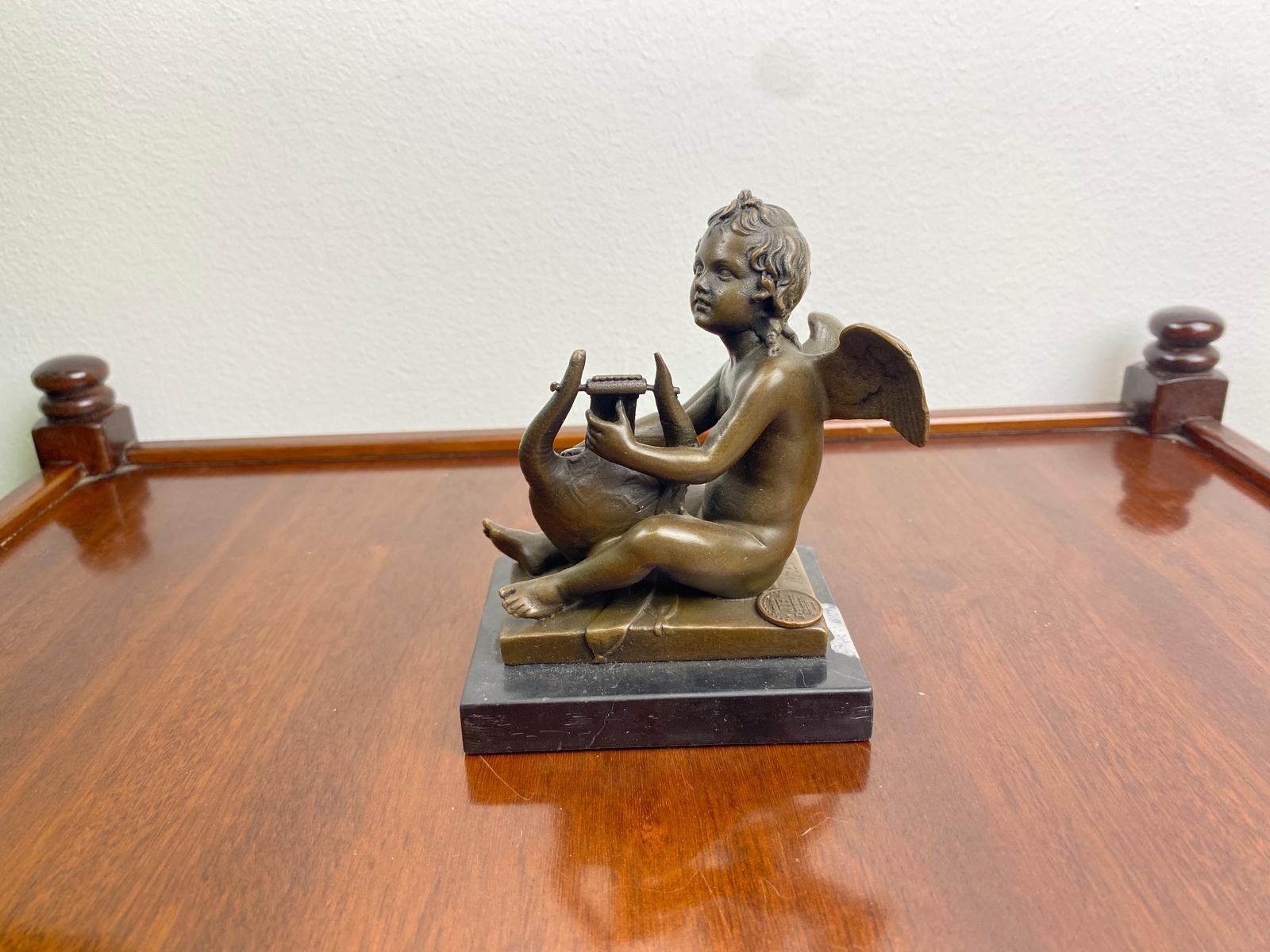 Bronze Sculpture of a Putto Playing Lyre on a black marble base after Milo