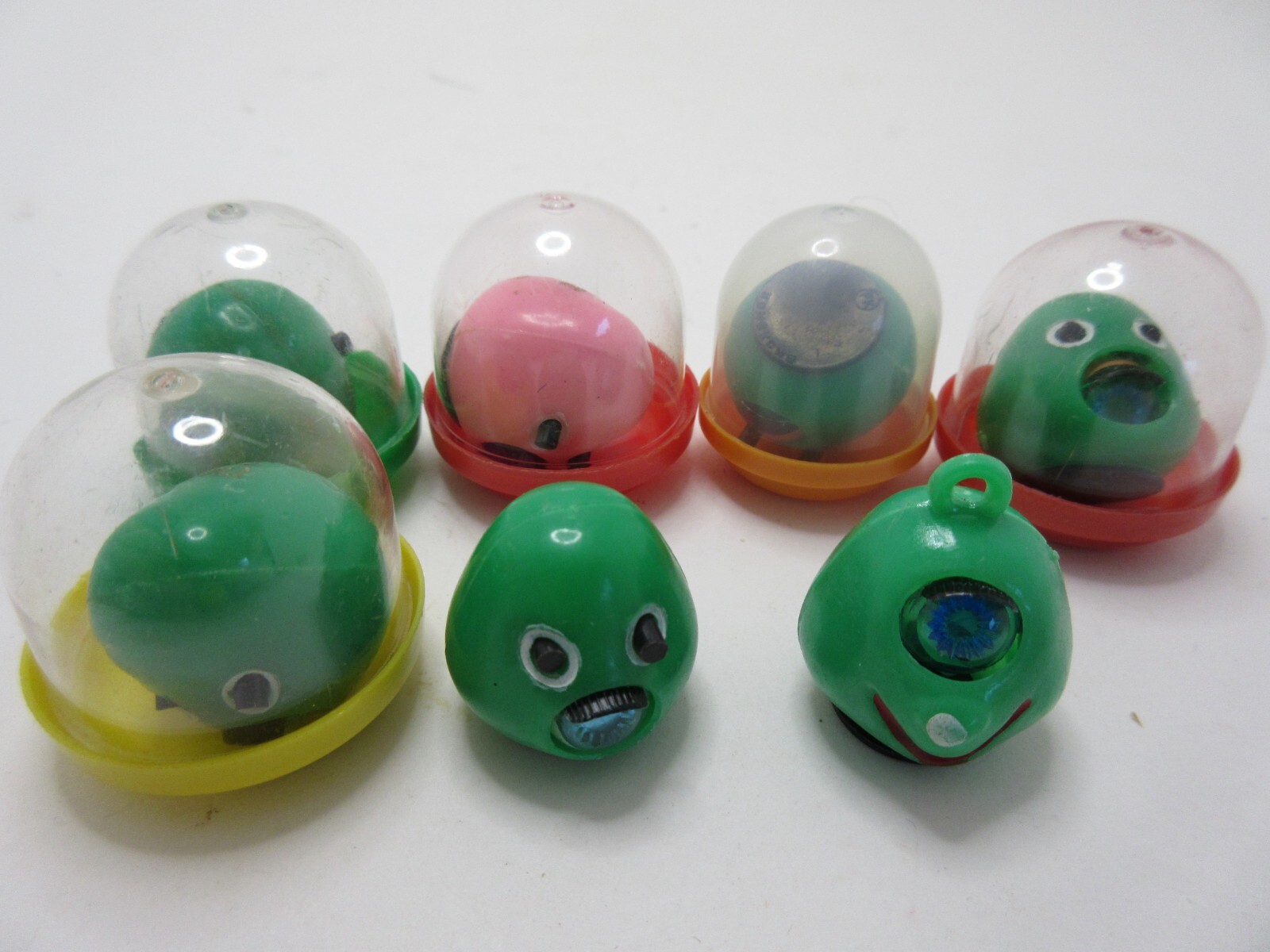 7 Old Vintage Gumball Vending Machine Charms Toys Green Eyed Monster