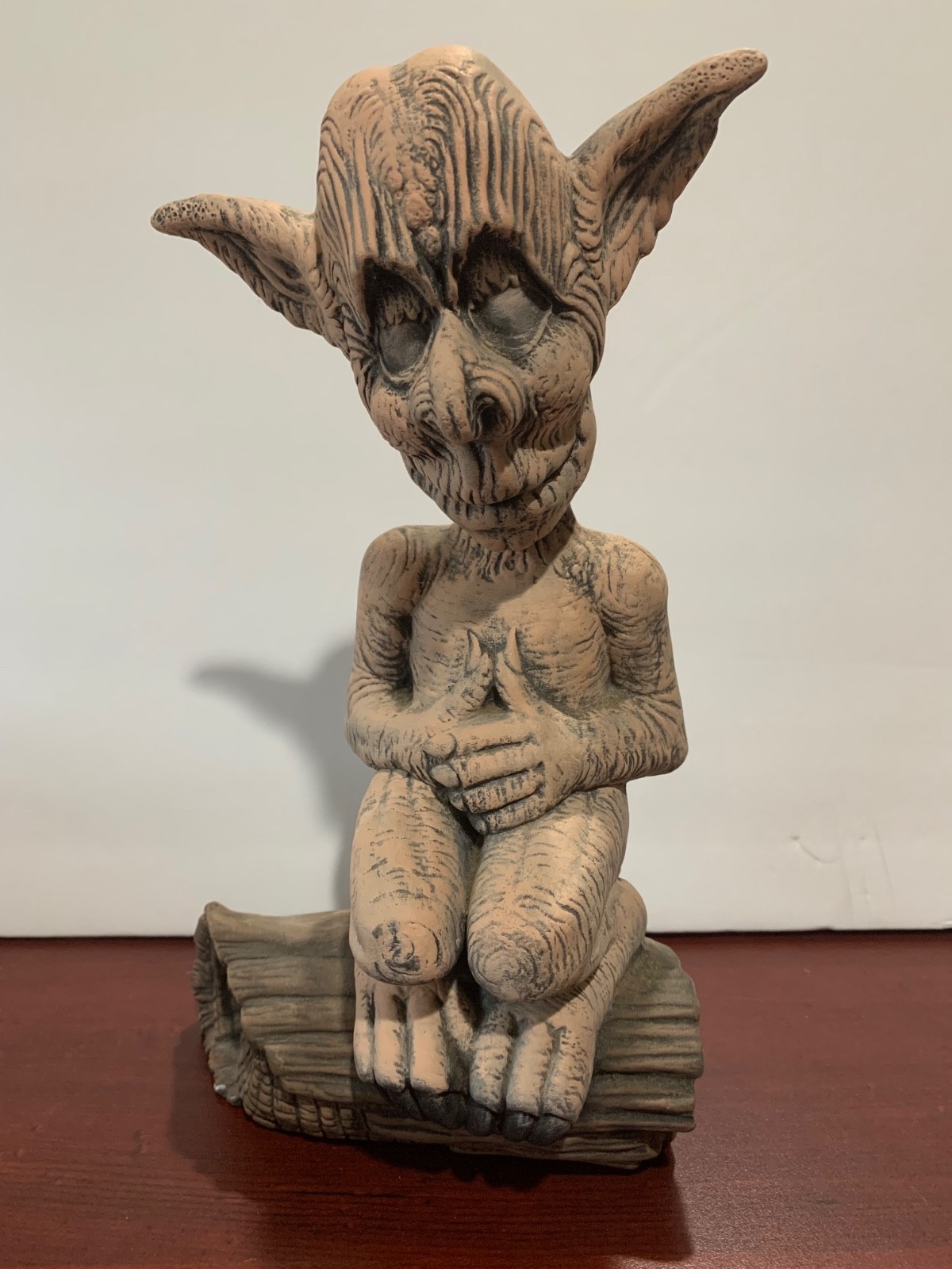 Ceramic 10" Elf sitting on a log