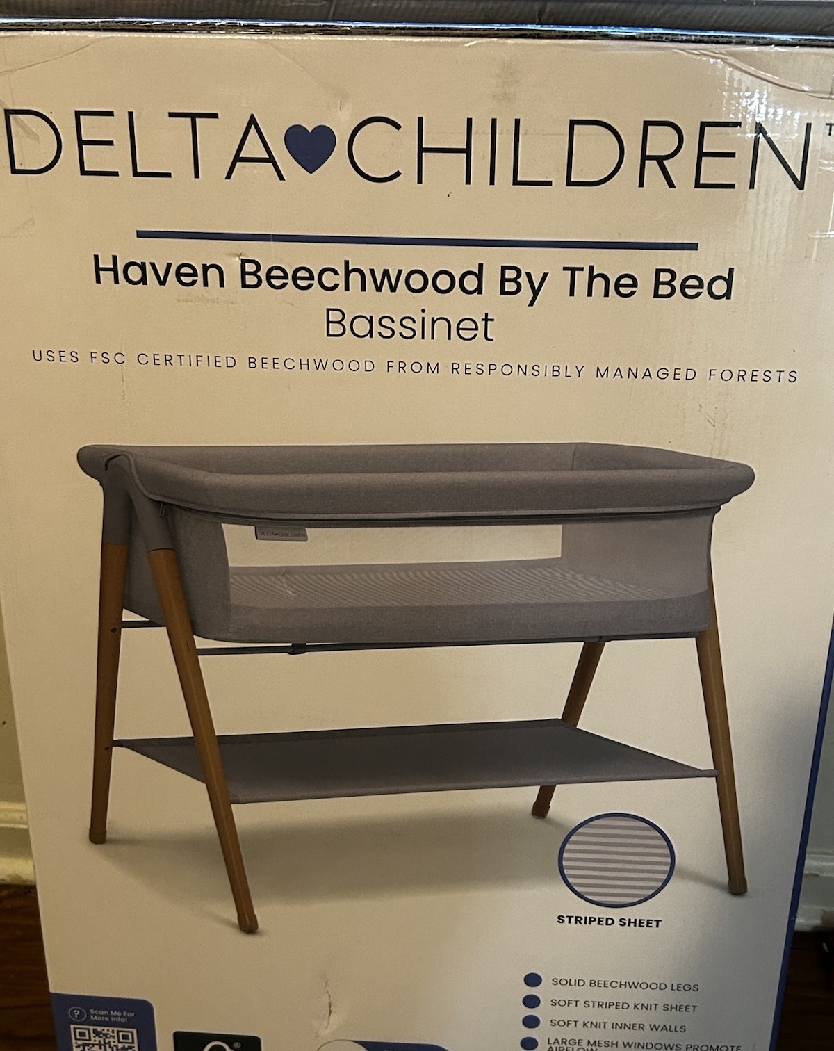 Delta Children Haven Beechwood Bassinet Solid Beechwood Legs Striped Sheet Mesh