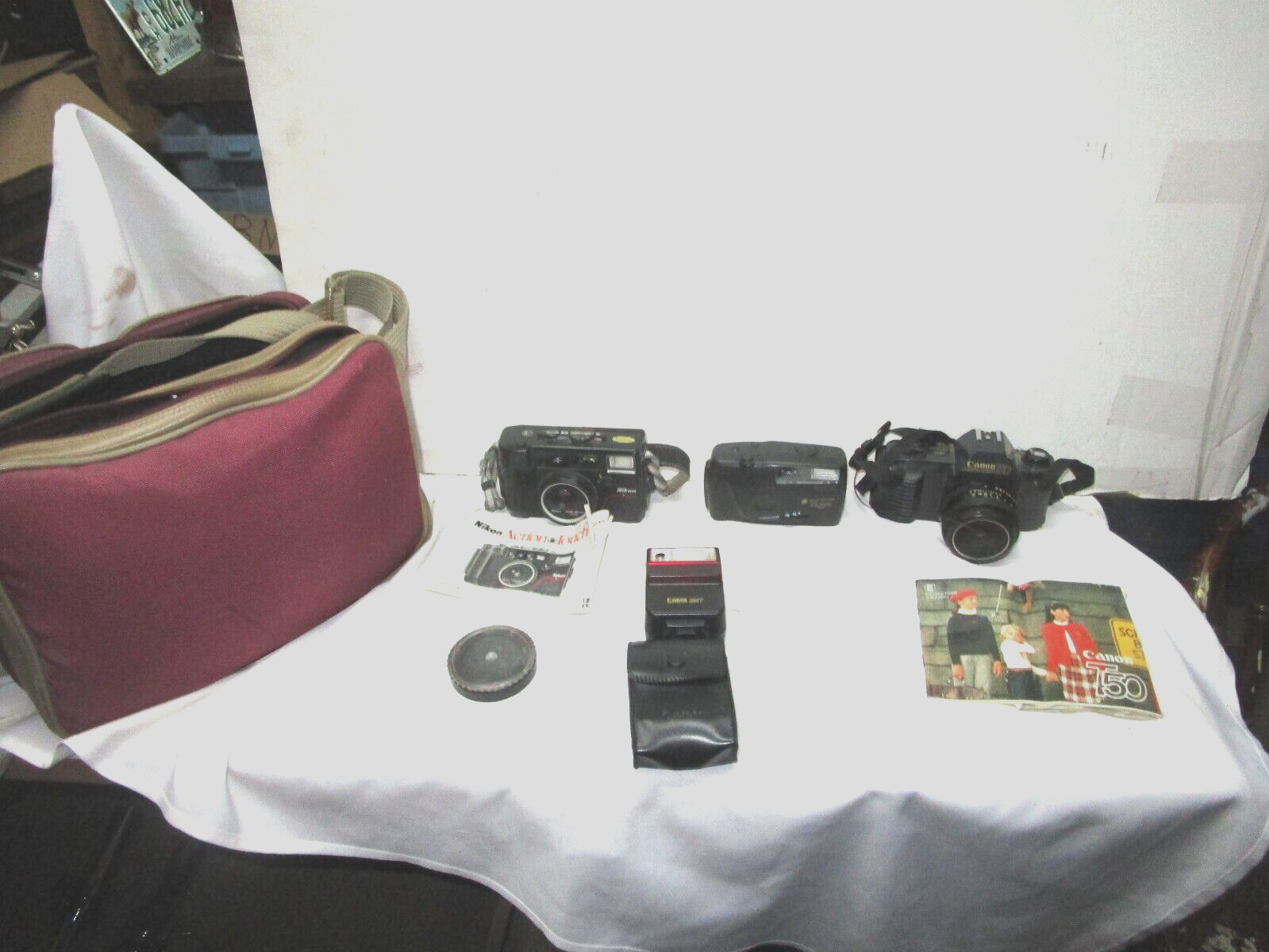 Lot of 35 mm cameras, carrying bag, instruct. booklets--Nikon, Canon, etc.