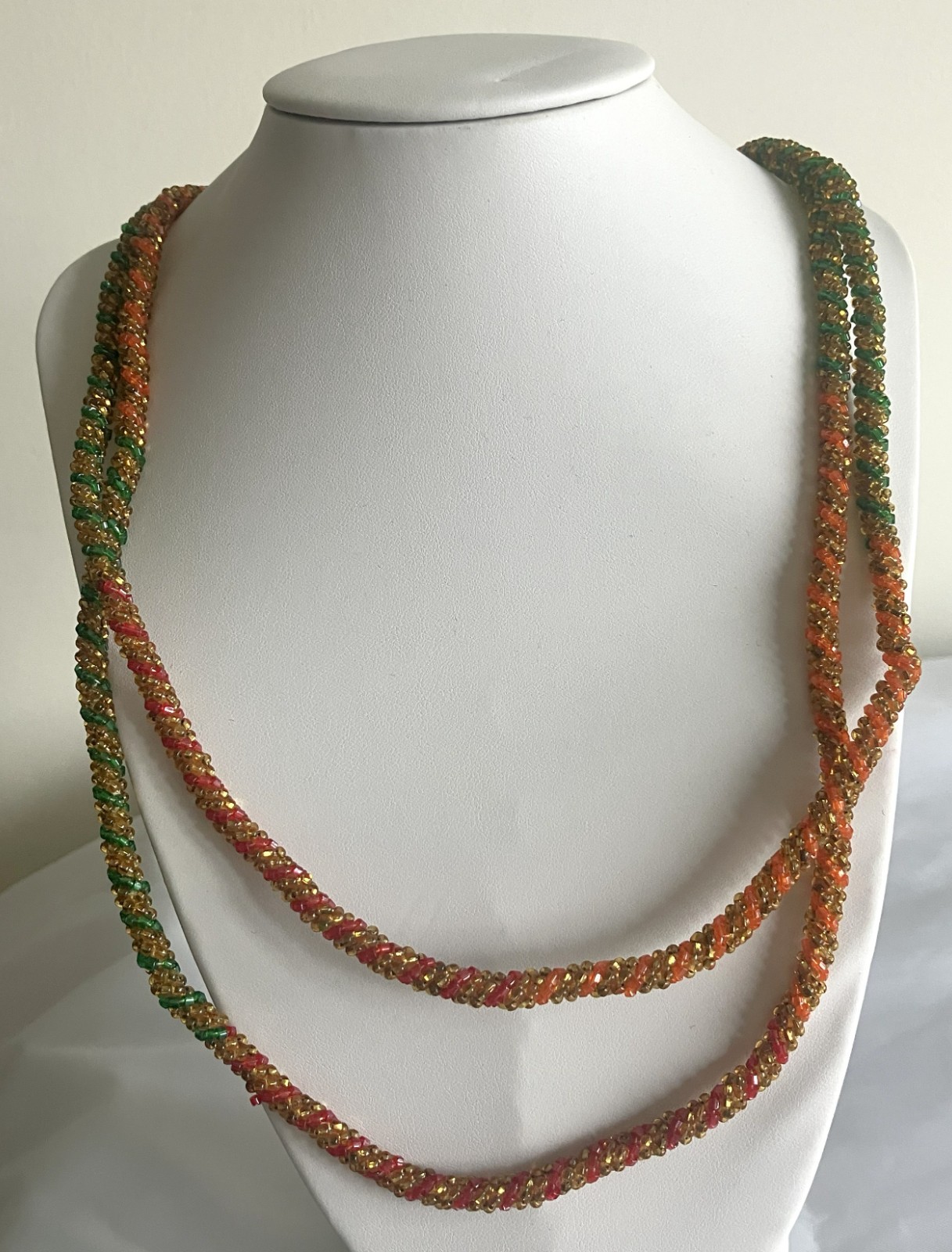 54 inch long red, orange & green spiral seed bead necklace